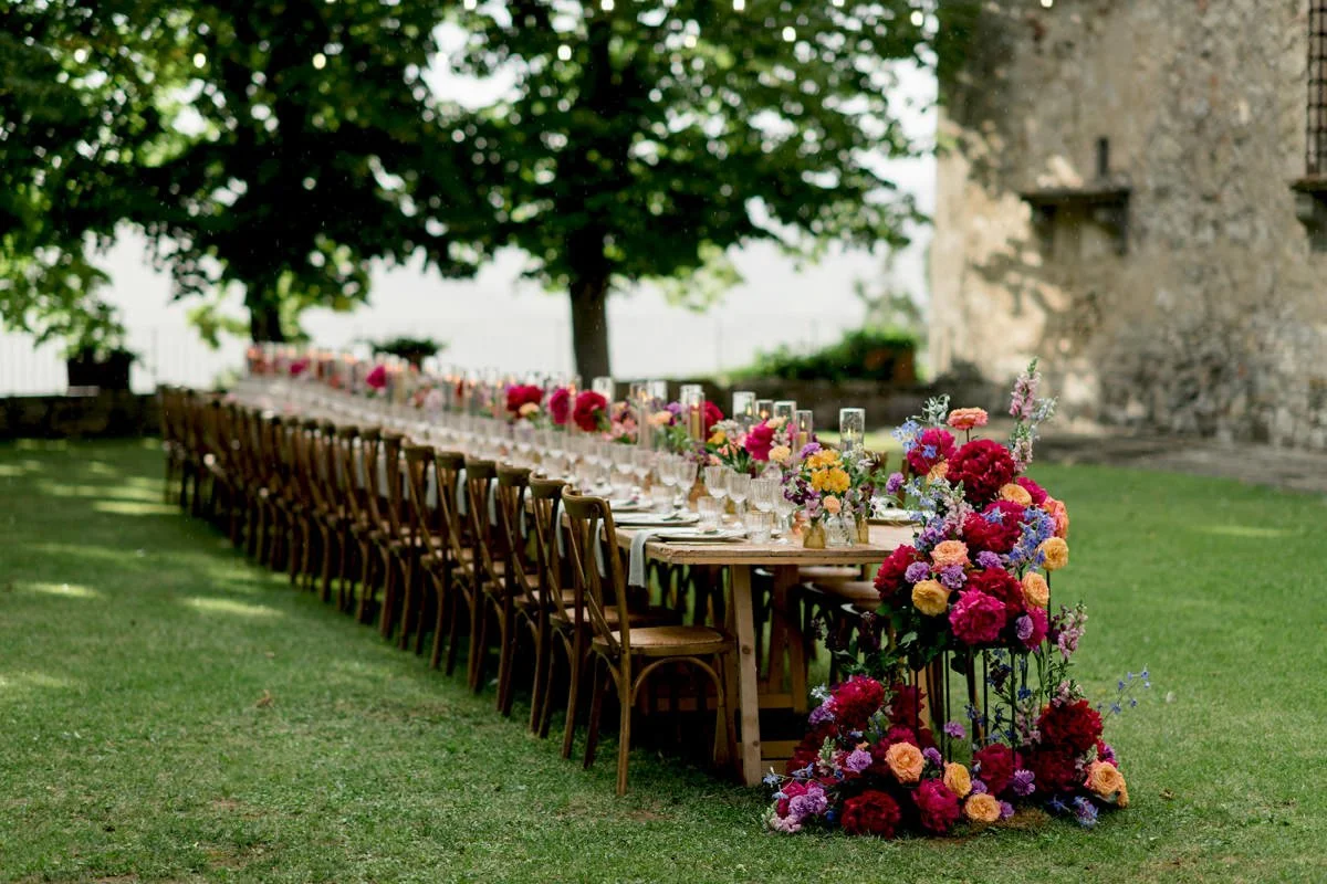 Wedding dinner table at Castello di Meleto with abundant floral design by FunkyBird Weddings.