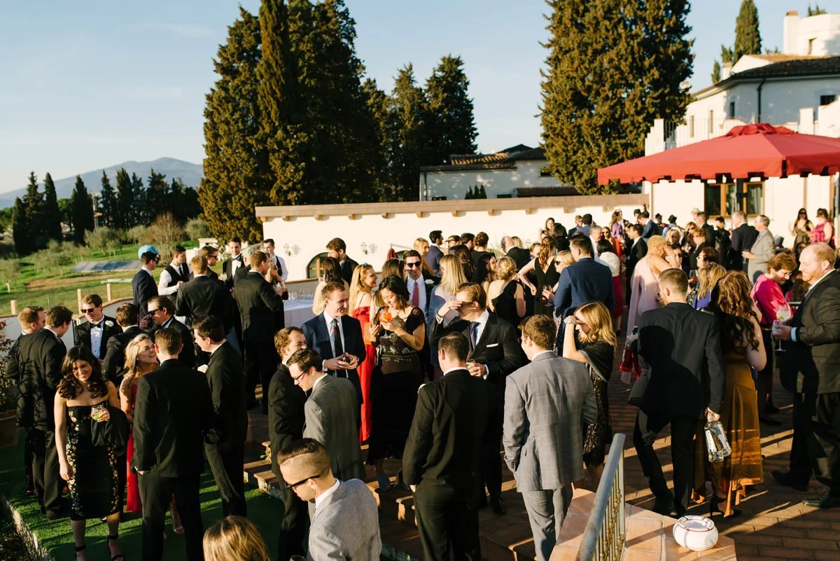 Wedding guests gathered on the panoramic terrace during aperitivo at Villa Hotel Tolomei in Florence.