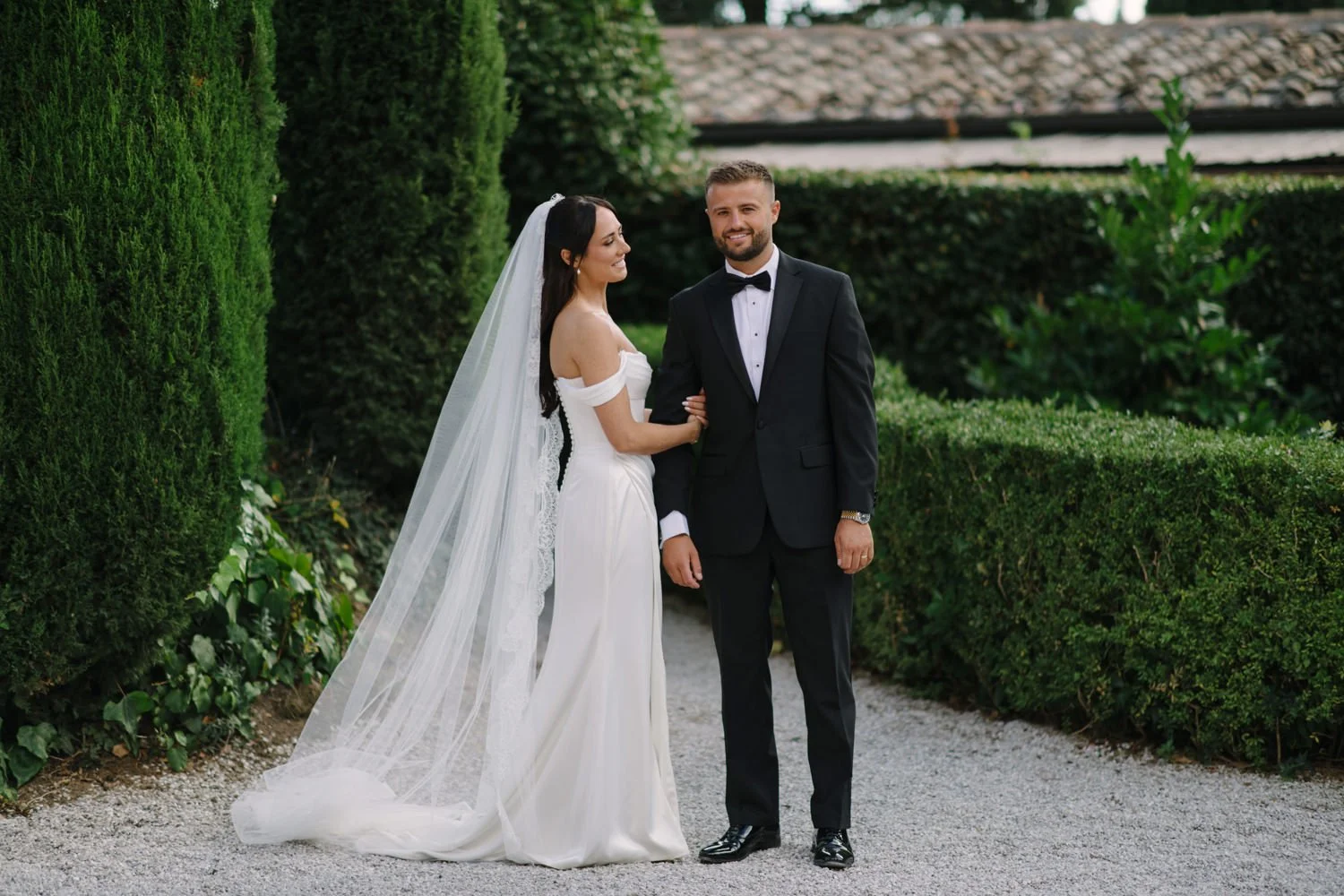 Bride and groom in the formal cypress garden of Villa di Ulignano, October wedding by FunkyBird Photography