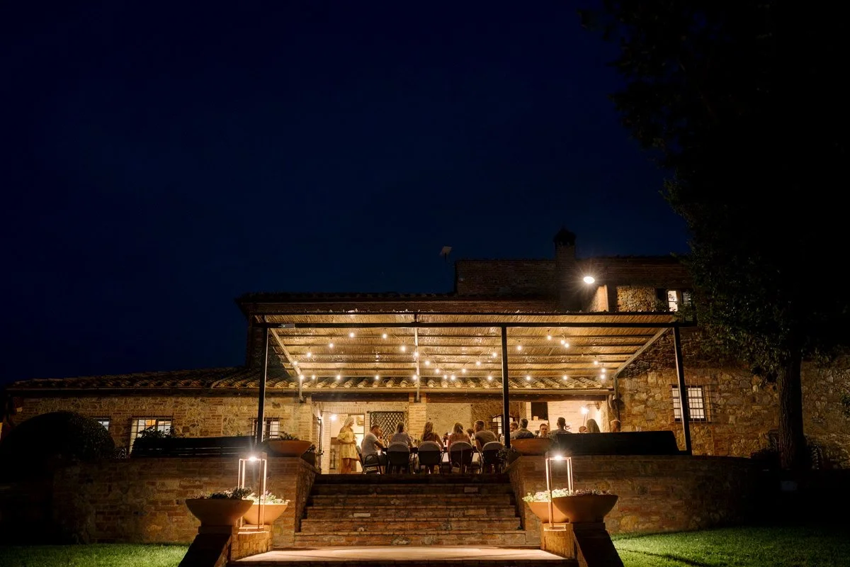 Night view of Villa Boscarello illuminated during a wedding celebration in Tuscany.