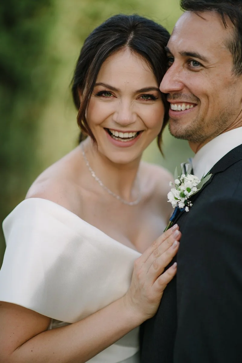 Close portrait of the bride and groom smiling together during their wedding at Villa Boscarello in Tuscany.