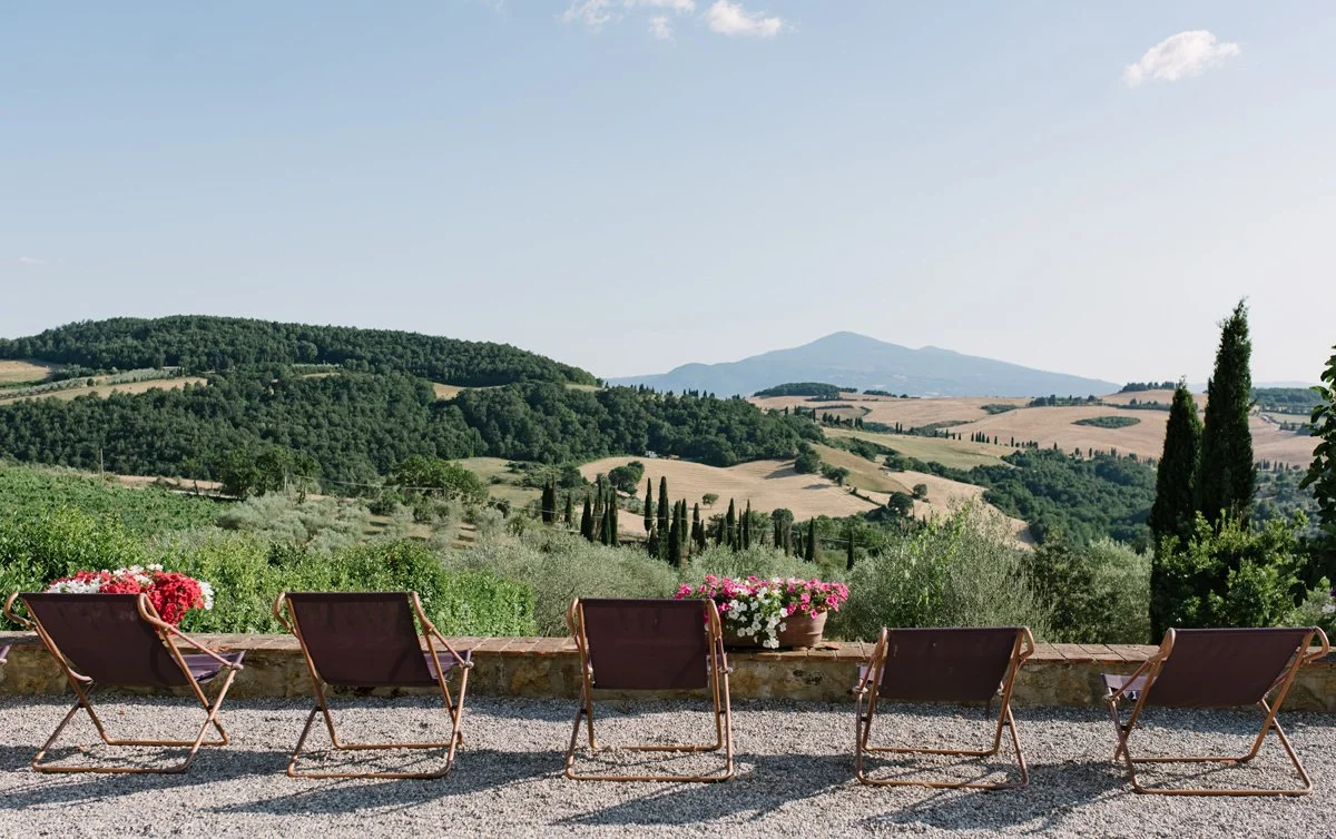Sun loungers at Terre di Nano overlooking the rolling Tuscan hills of Val d’Orcia.