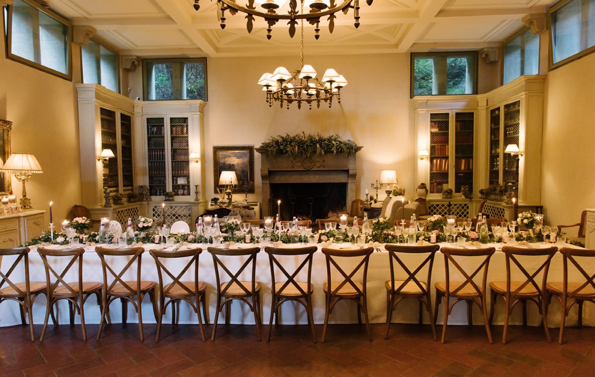 Long wedding dinner table set inside Villa Le Fontanelle for an elegant celebration in Florence.