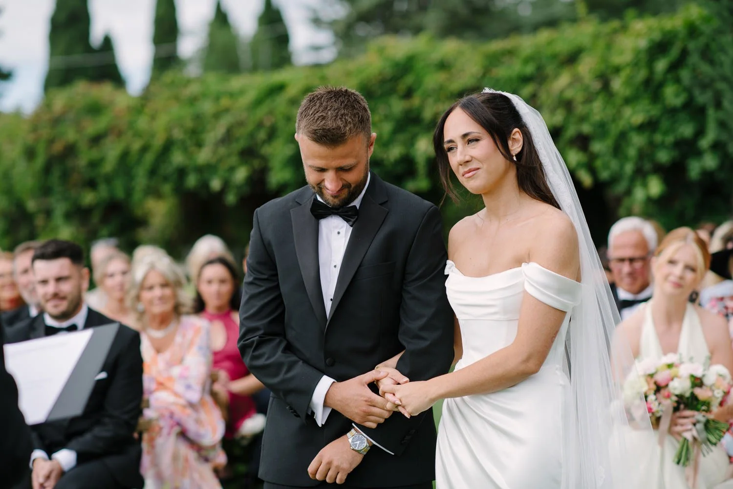 Bride and groom during the symbolic ceremony at Villa di Ulignano with guests watching, FunkyBird Photography