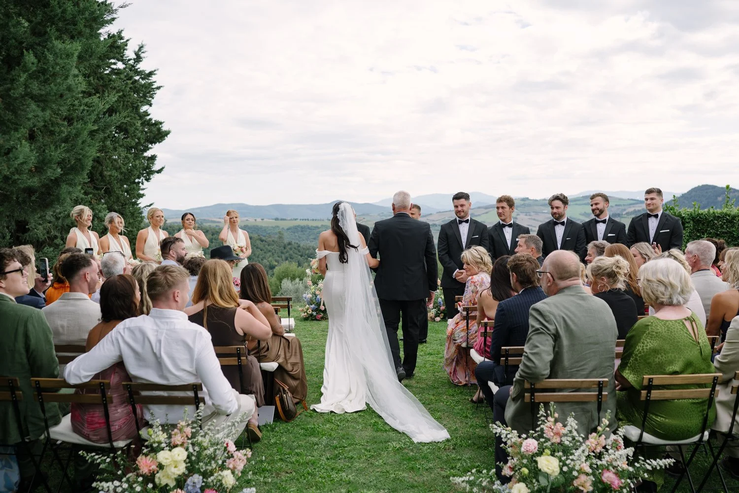 Bride walking down the aisle with the Volterra countryside behind her, Villa di Ulignano ceremony by FunkyBird