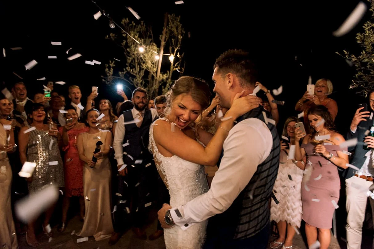 Wedding couple dancing their first dance surrounded by petals at Conti di San Bonifacio in Tuscany.
