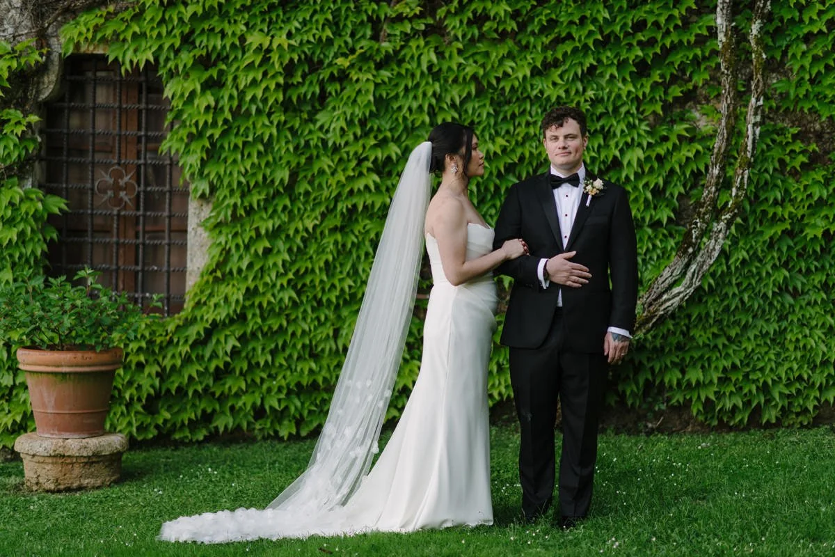 Bride and groom posing in the Italian gardens of Castello di Celsa, Tuscany wedding