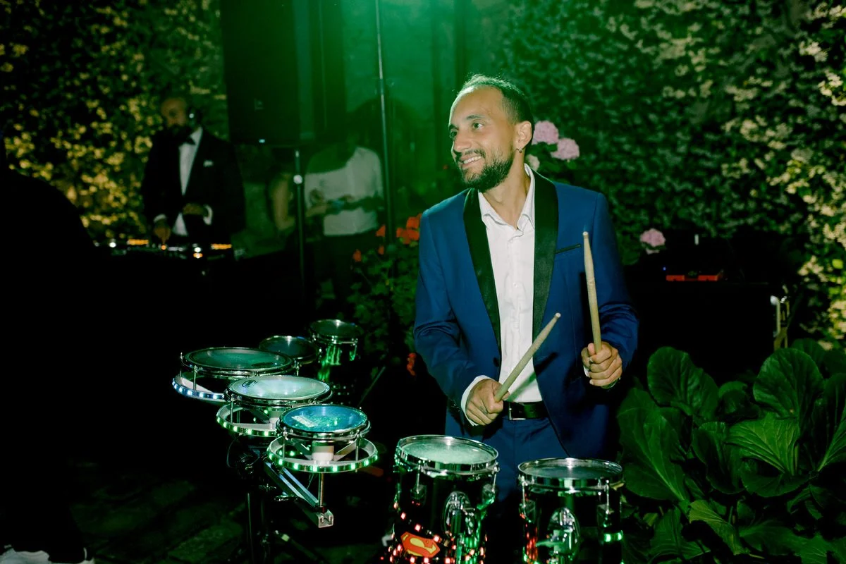 Musician playing drums during the wedding party at Castello di Bossi in Tuscany.