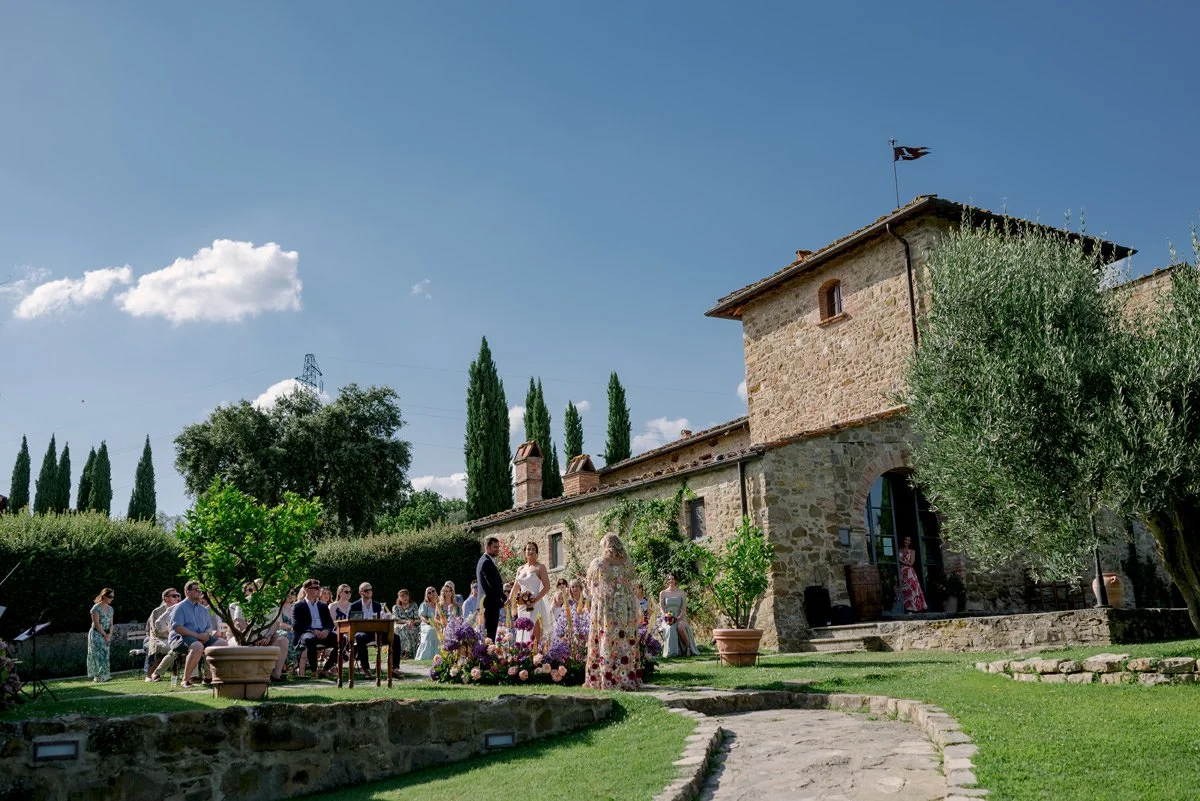 Wedding ceremony at Casa Cornacchi held beside the main building of the venue in the Tuscan countryside