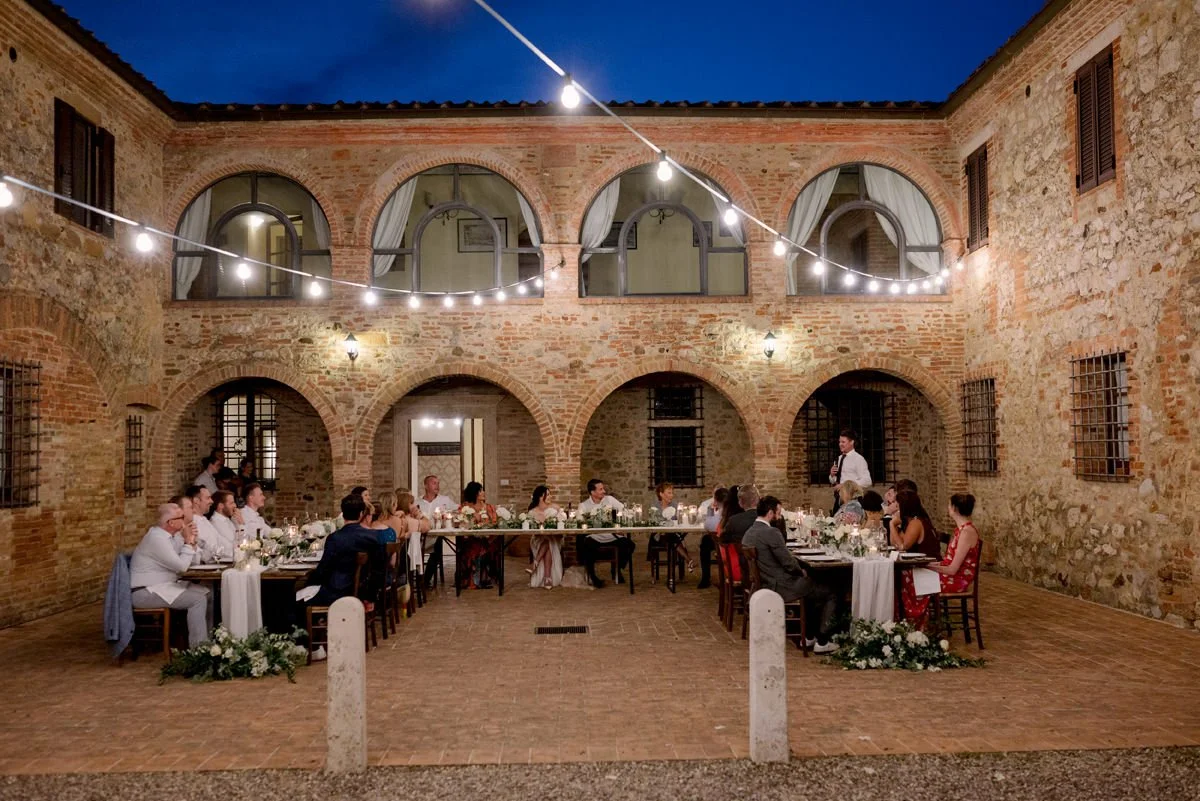 Guests seated at the wedding dinner table during the reception at Villa Boscarello in Tuscany.