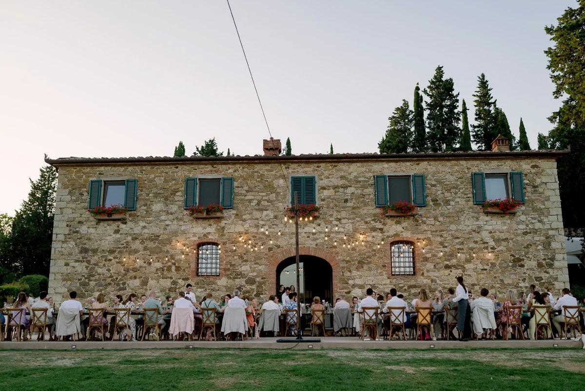 Long wedding dinner table set in front of the villa at Le Filigare wedding venue in Tuscany.