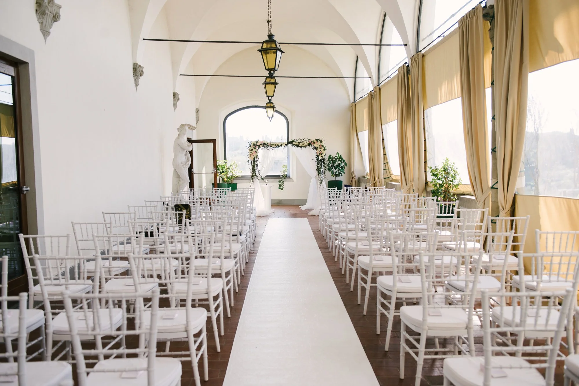 Wedding ceremony on the terrace of Villa Tolomei, an elegant villa hotel wedding venue in  Florence, Tuscany.