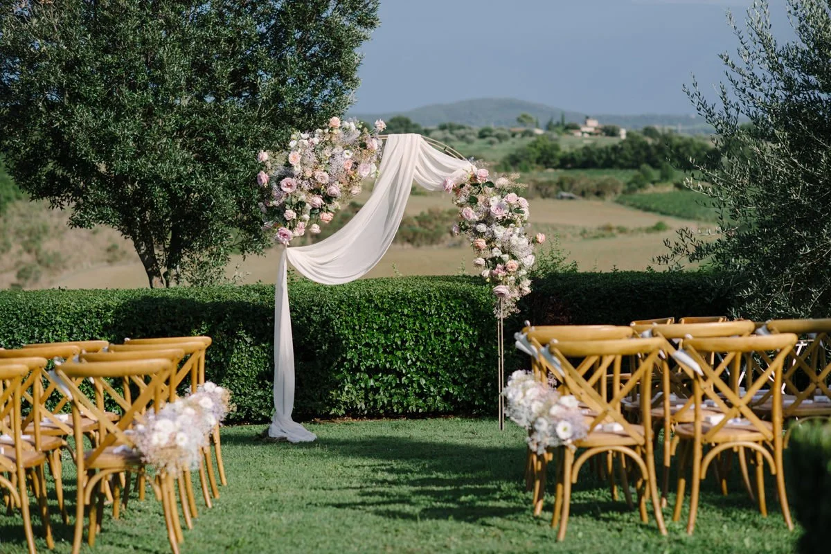 Wedding ceremony setup at Villa Boscarello with a floral arch prepared before guests arrive.
