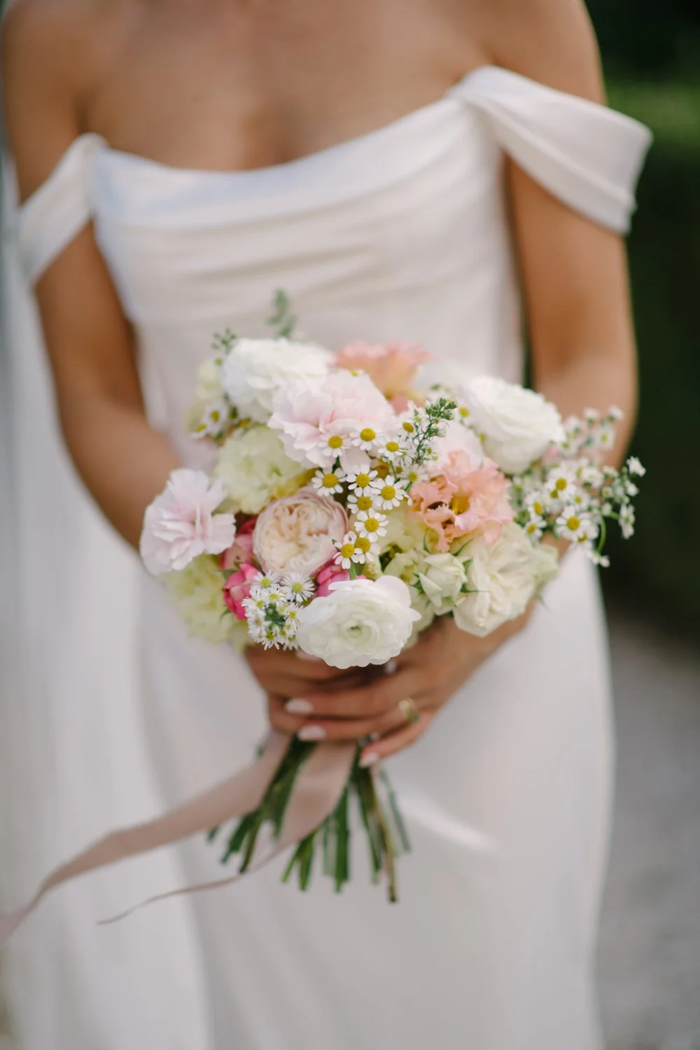 Bride's October bouquet of garden roses, ranunculus, lisianthus and feverfew daisies at Villa di Ulignano