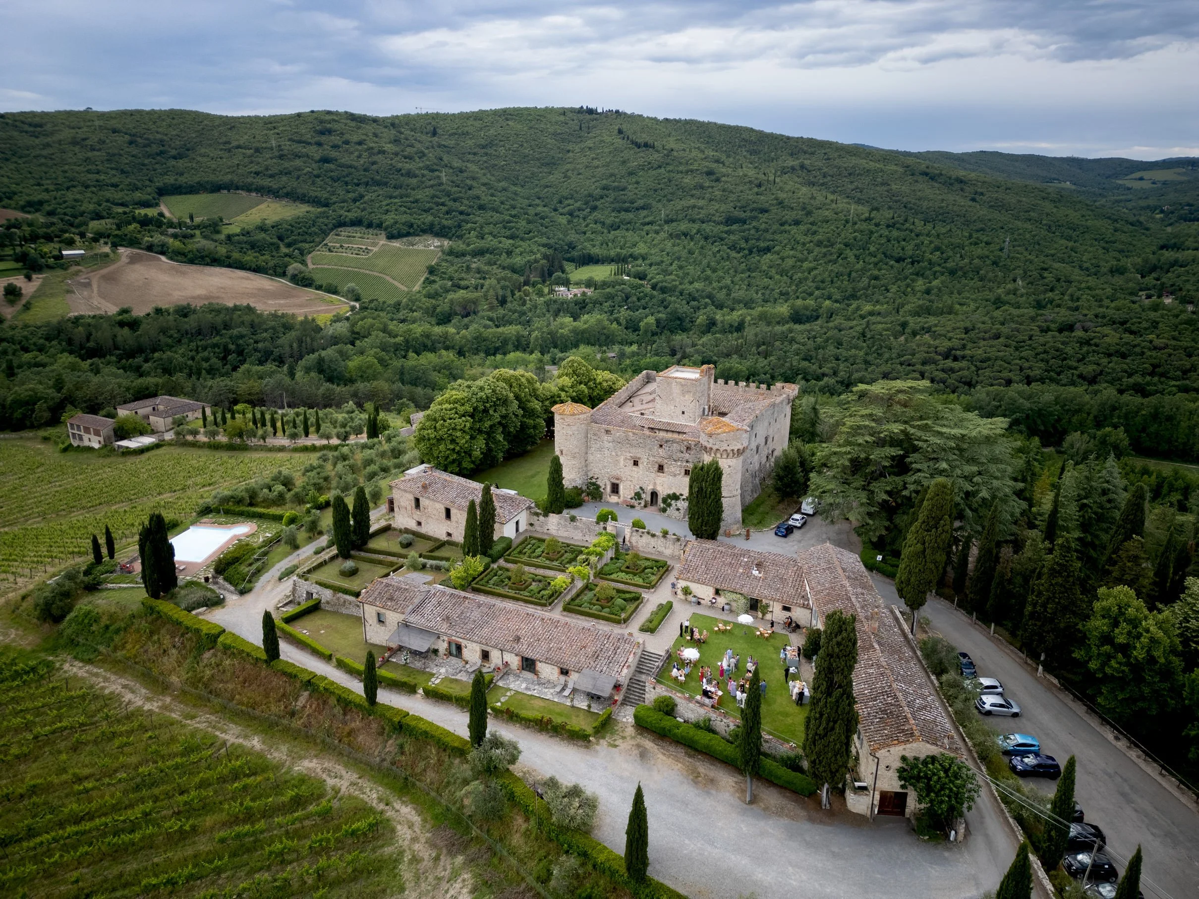 Castello di Meleto wedding venue in Tuscany seen from above, showing the castle, Italian garden, and surrounding Chianti vineyards.