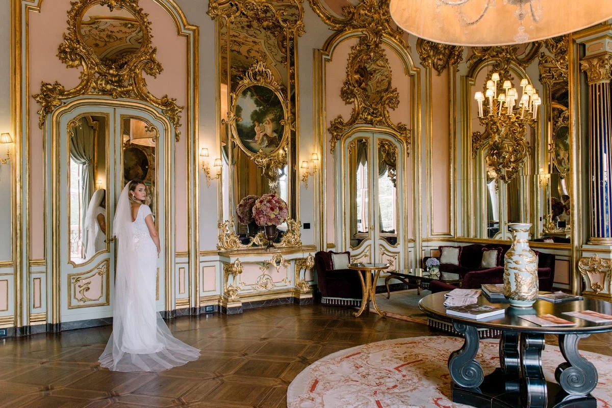 Bride posing inside one of the grand interior rooms at Villa Cora, surrounded by historic decor.