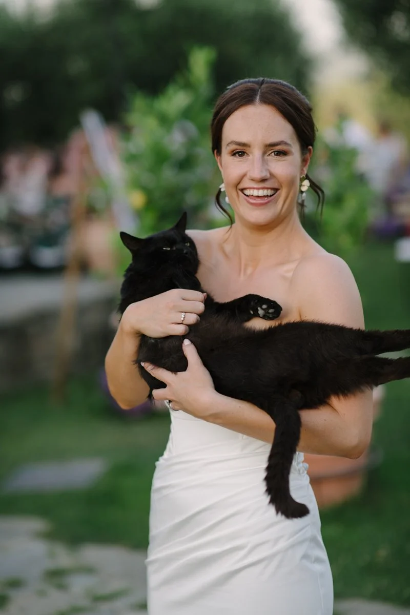 Beautiful photo of the bride holding the cat from Tuscany wedding venue