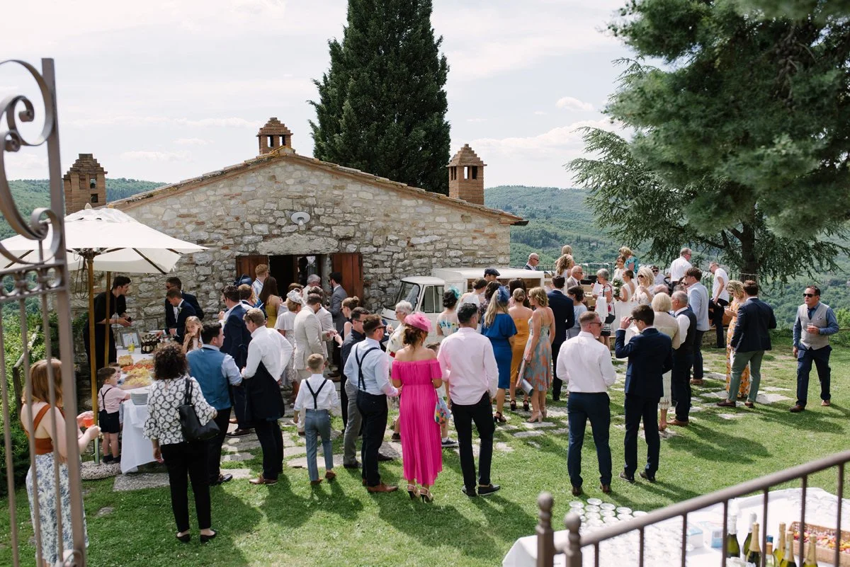 Guests gathering during aperitivo at Borgo Pietrafitta with Tuscan countryside views.