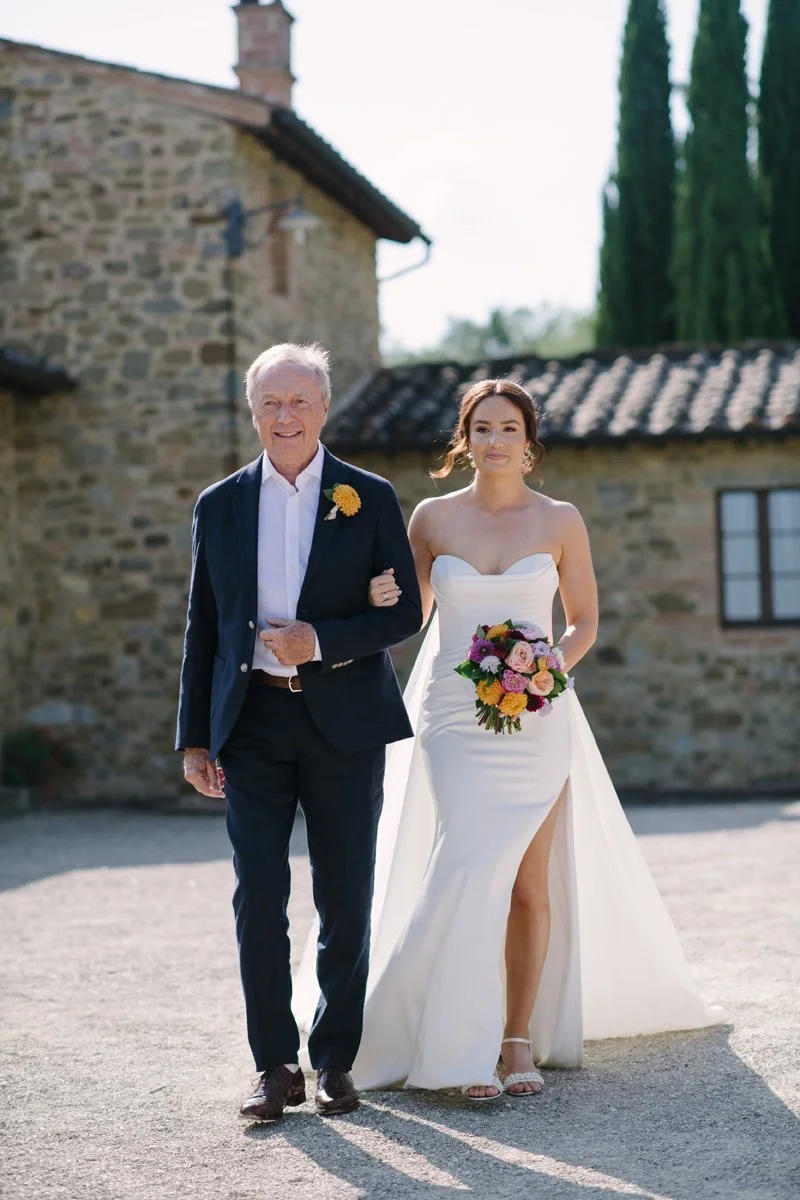 Bride walking with her father to the ceremony at Casa Cornacci wedding