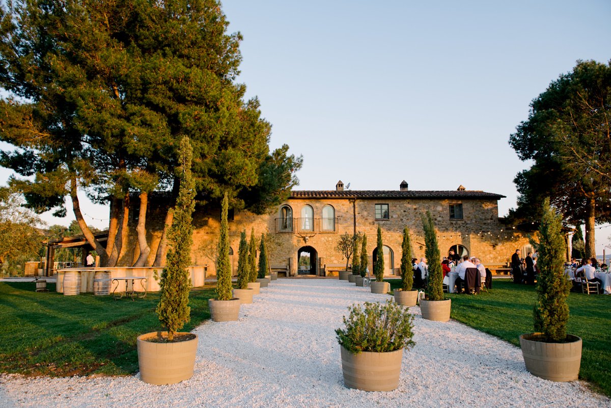 View of Conti di San Bonifacio entrance and villa during sunset in Tuscany.