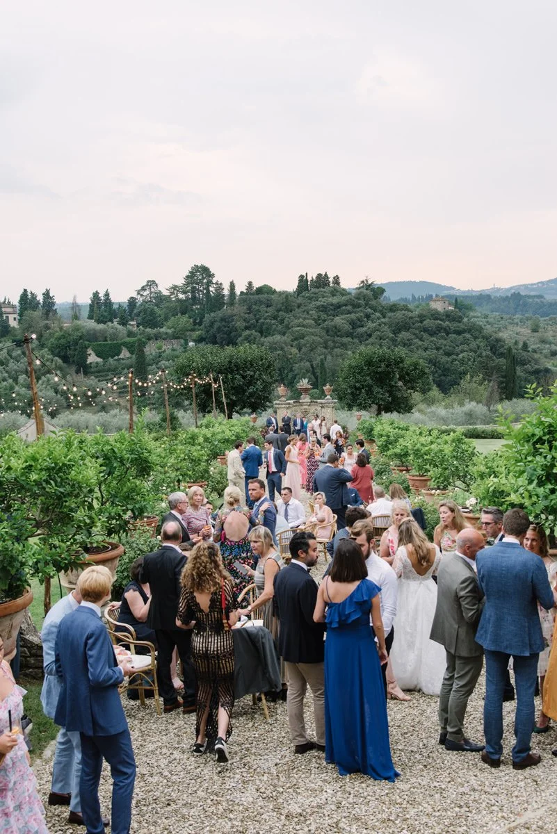 Wedding guests enjoying aperitivo in the garden at Villa Medicea di Lilliano