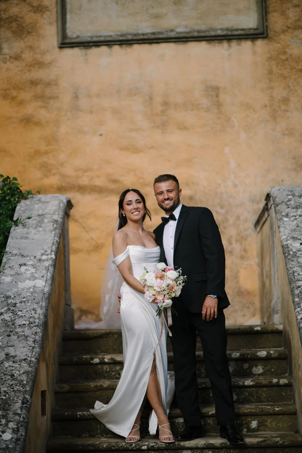 Bride and groom portrait on the front stairs of Villa di Ulignano in golden October light, FunkyBird Photography