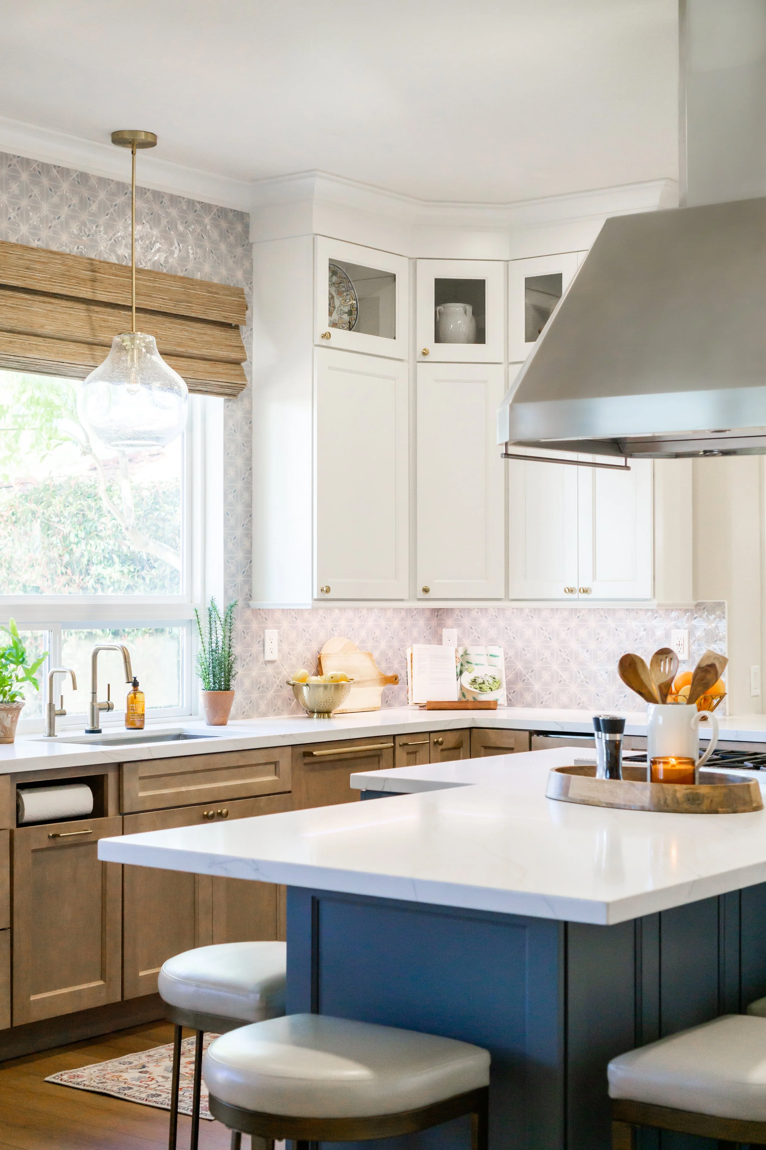Luxury kitchen remodel in Fullerton, California featuring custom shaker cabinetry, an island, quartz countertops, a custom range hood, and warm transitional design details by Apex Construction & Restoration Inc.