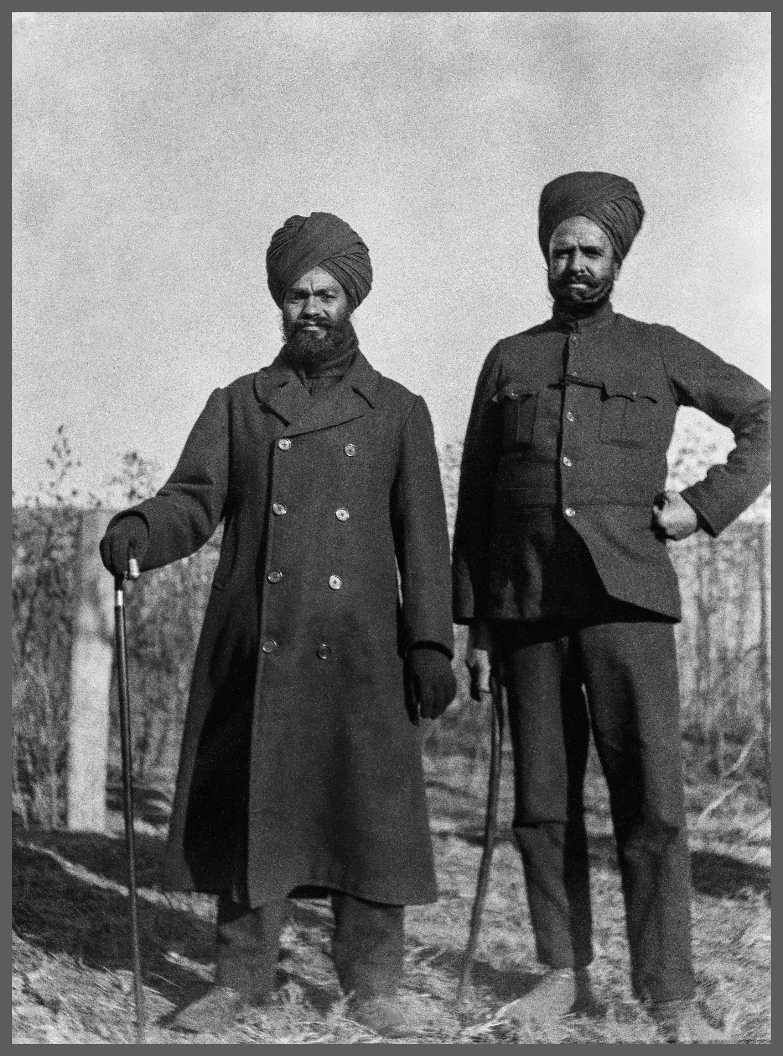 Two officers, likely from India pose for a portrait.