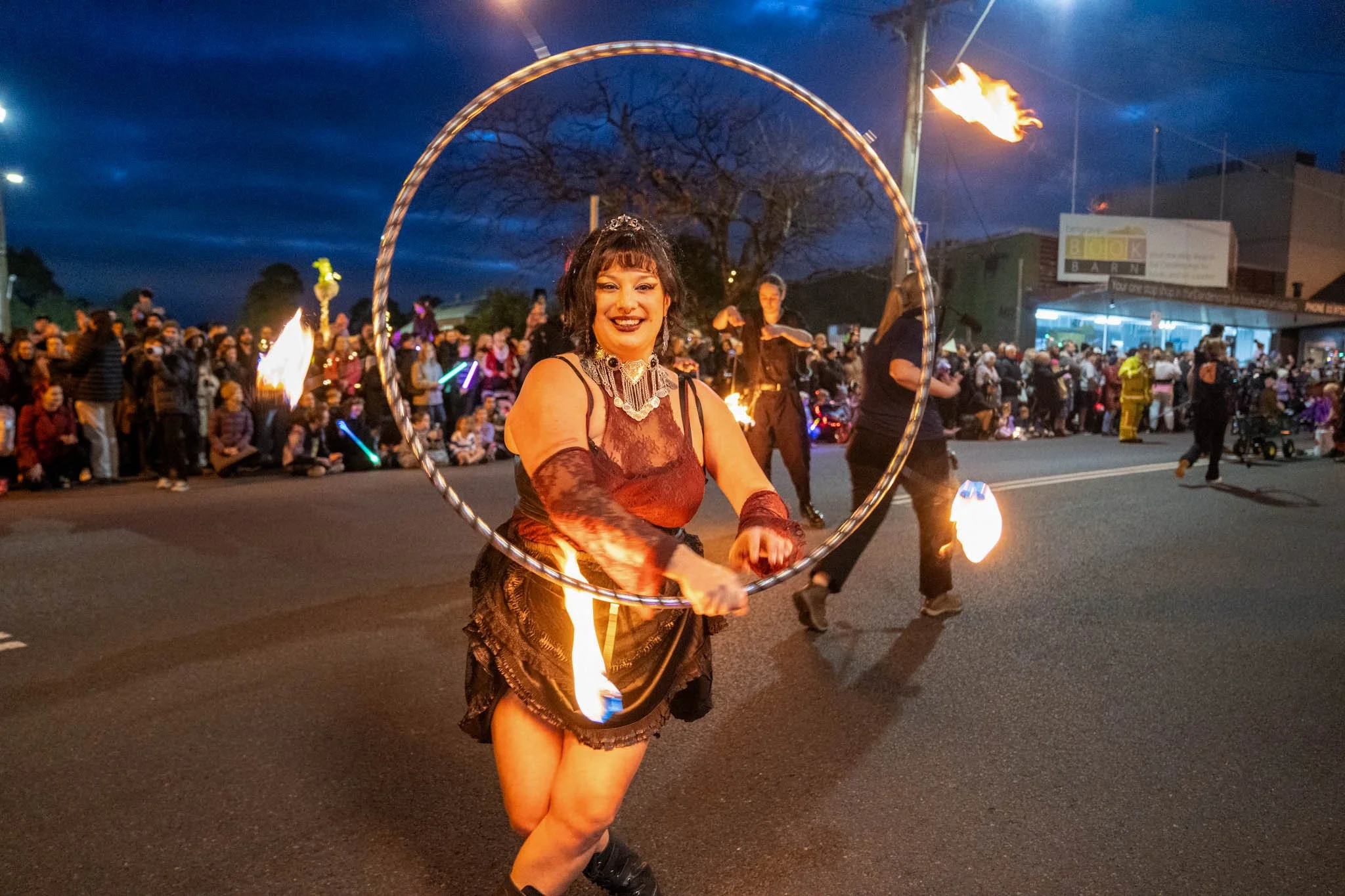 A fire twirler lights up the winter solstice sky at the Belgrave Lantern Festival 2024