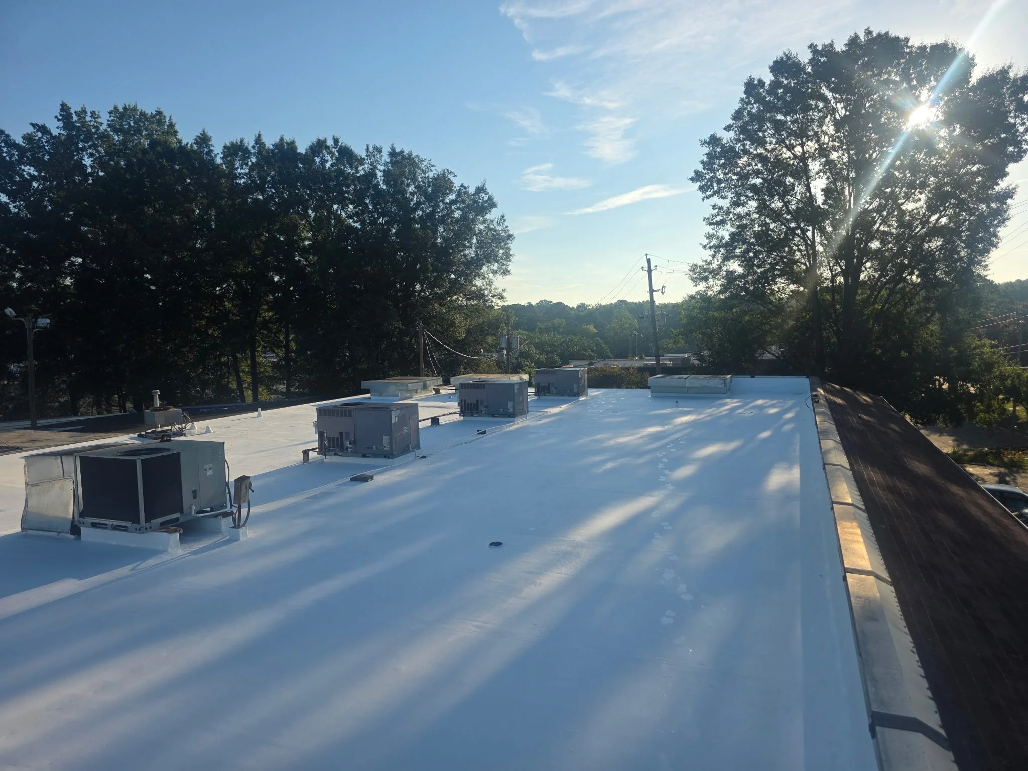 Commercial silicone roof restoration completed over an existing TPO roofing system for a retail facility, providing a seamless protective coating designed to extend roof service life, improve weather resistance, and reduce lifecycle costs.