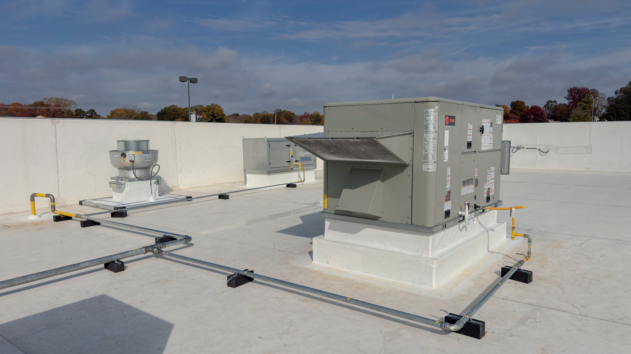 Commercial Tenant Build-Out Roof Modifications Upright Roofing Services completed commercial roof modifications for a tenant build-out, including new equipment curbs, TPO membrane flashing, and rooftop waterproofing to support new mechanical installa