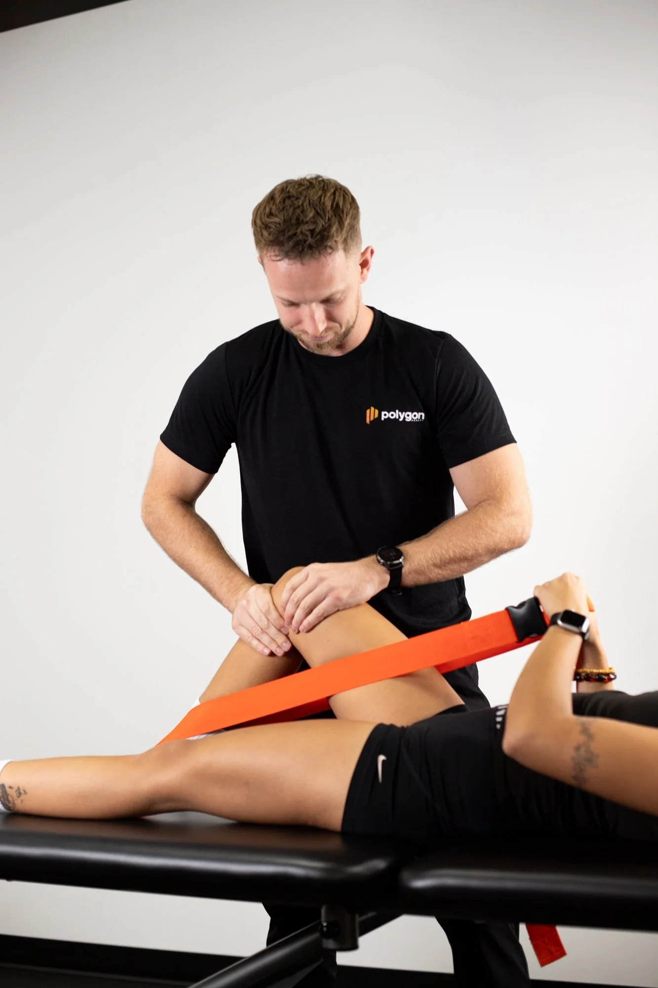 Physiotherapist Connor Fraser treating a patient's knee at Polygon Health in Burnaby