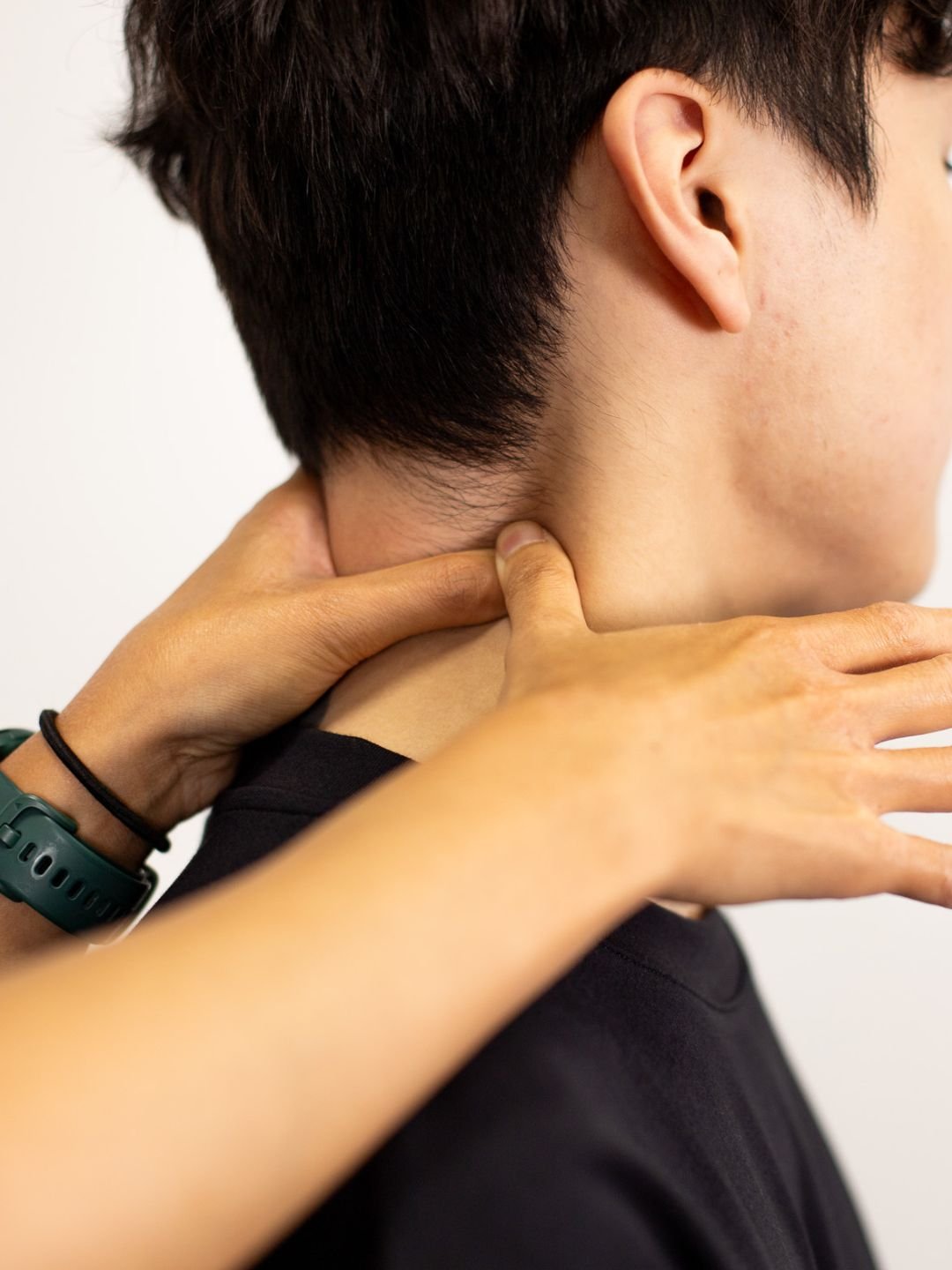 A woman providing neck therapy to a man lying on a chiropractic table.