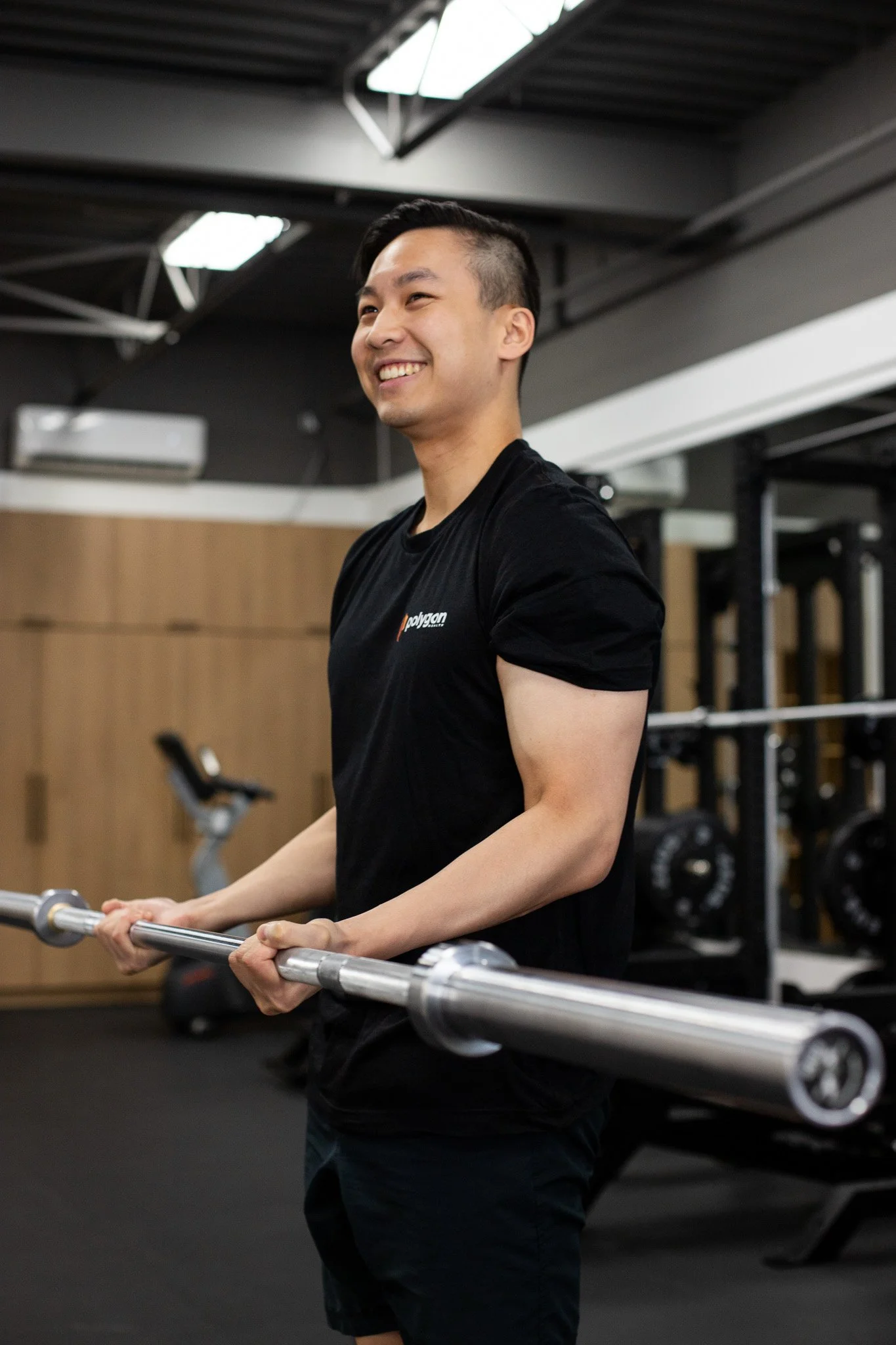 Physical therapist assisting a patient with leg exercises on a pilates reformer machine