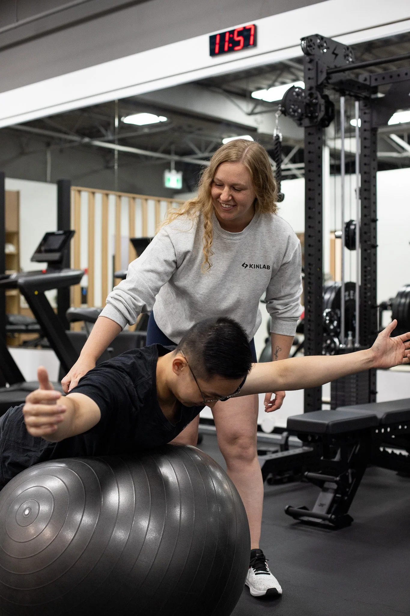 A woman providing neck therapy to a man lying on a chiropractic table.