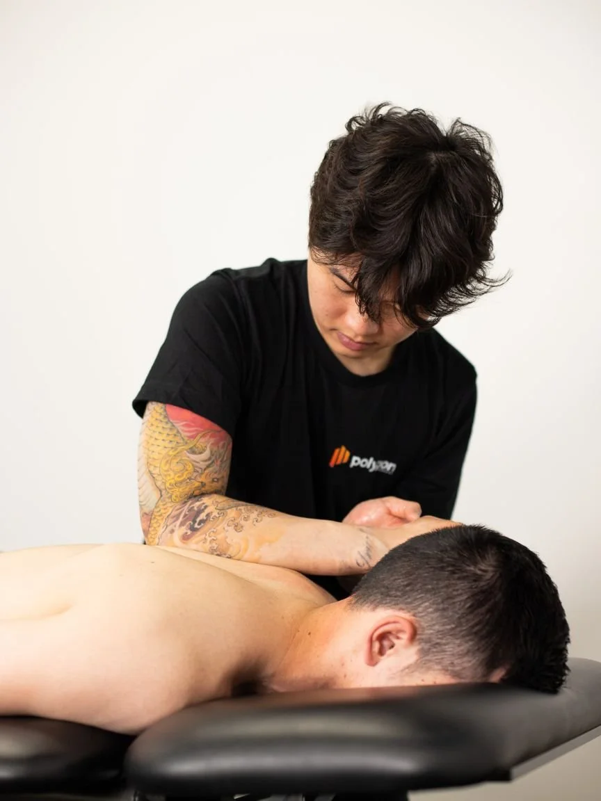 A woman providing neck therapy to a man lying on a chiropractic table.