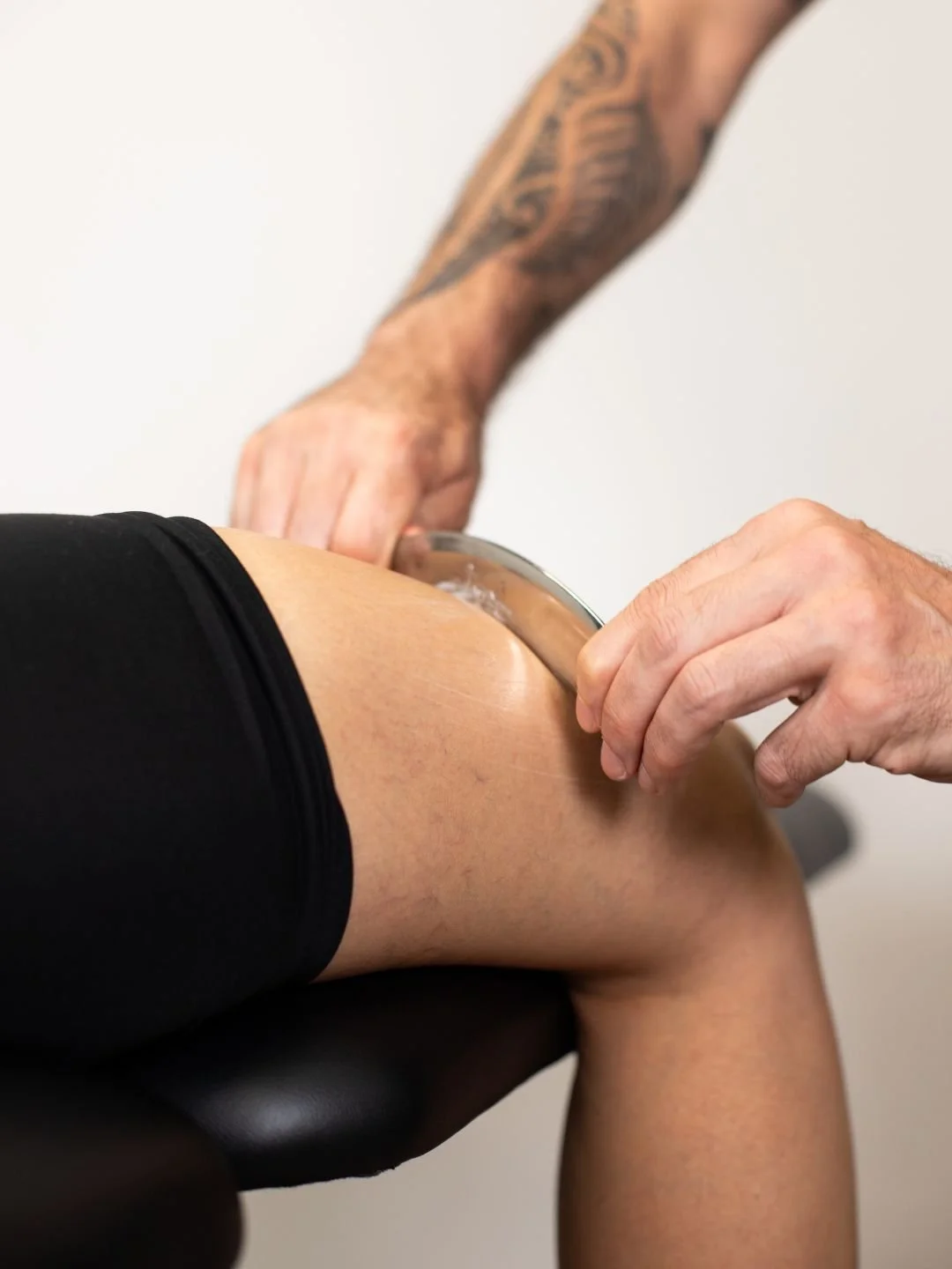 A woman providing neck therapy to a man lying on a chiropractic table.