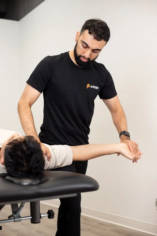 Physical therapist assisting a patient with leg exercises on a pilates reformer machine