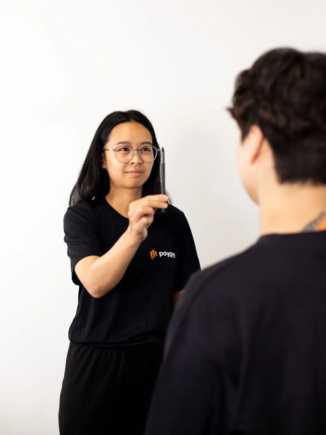 A woman providing neck therapy to a man lying on a chiropractic table.