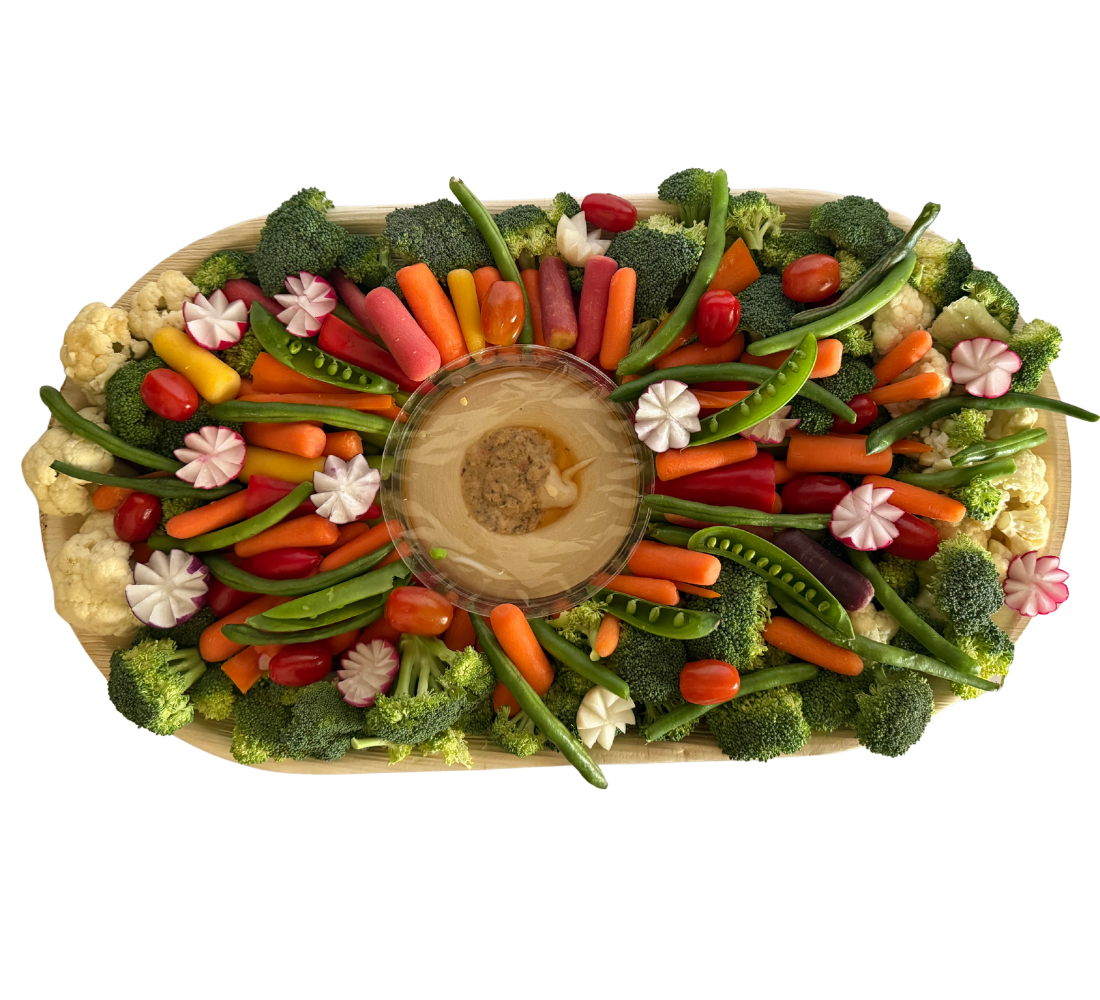 An outstanding vegetable platter board with hummus, radishes, cauliflower, carrots, and green beans from Brie & Burrata in San Diego.
