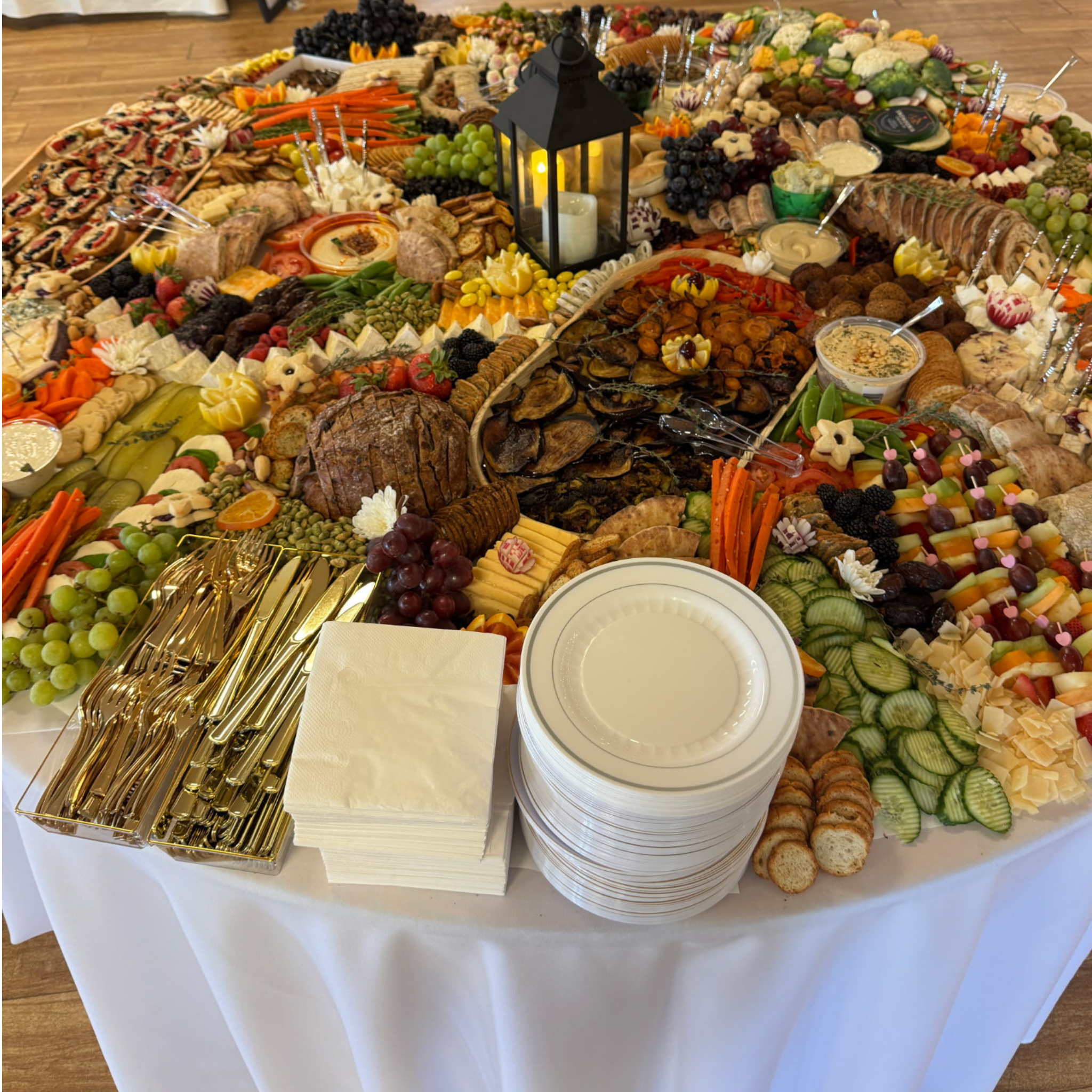 A beautiful round grazing table created by San Diego caterer Brie and Burrata for a wedding.