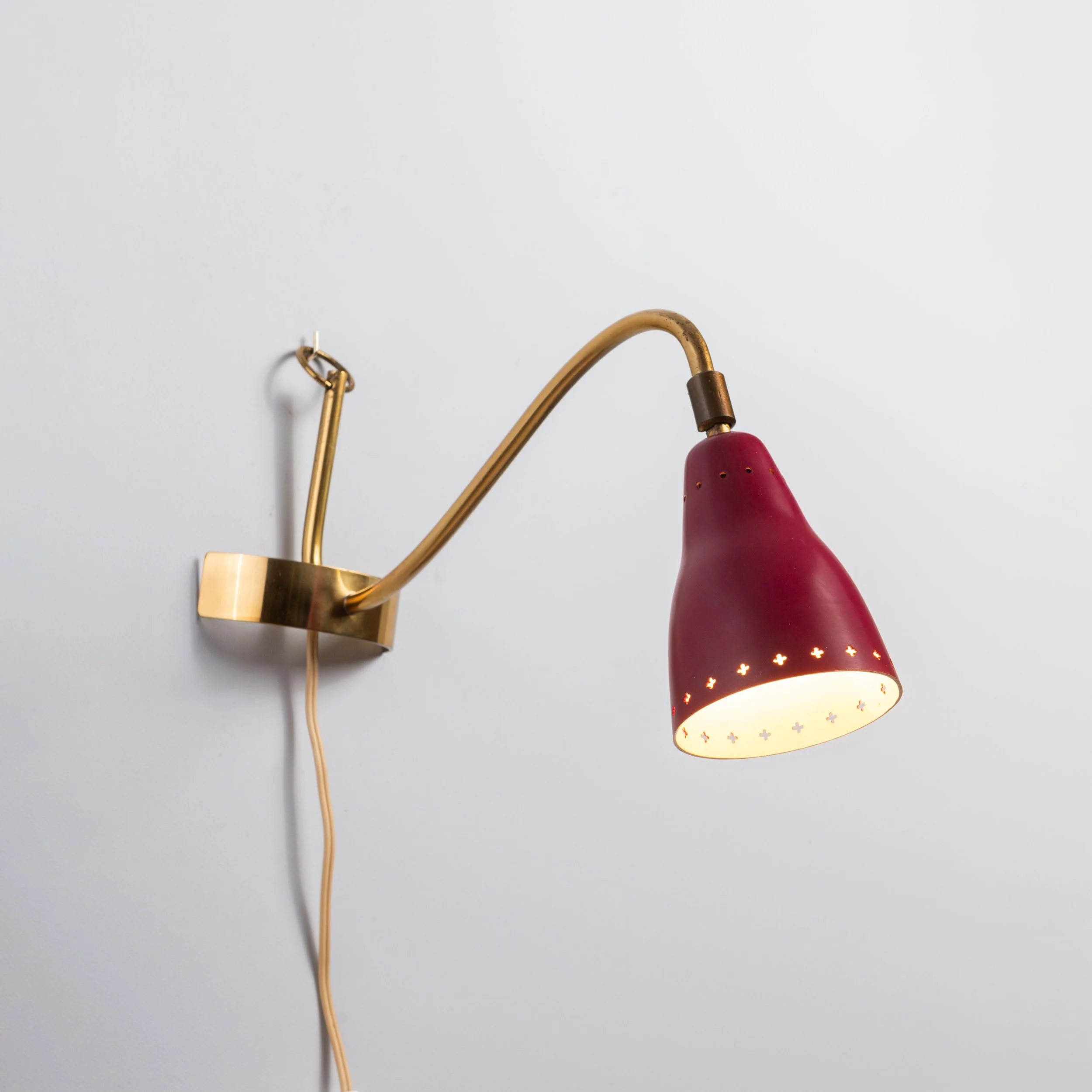 Brass wall lamp with perforated metal shade, 1950s, Sweden