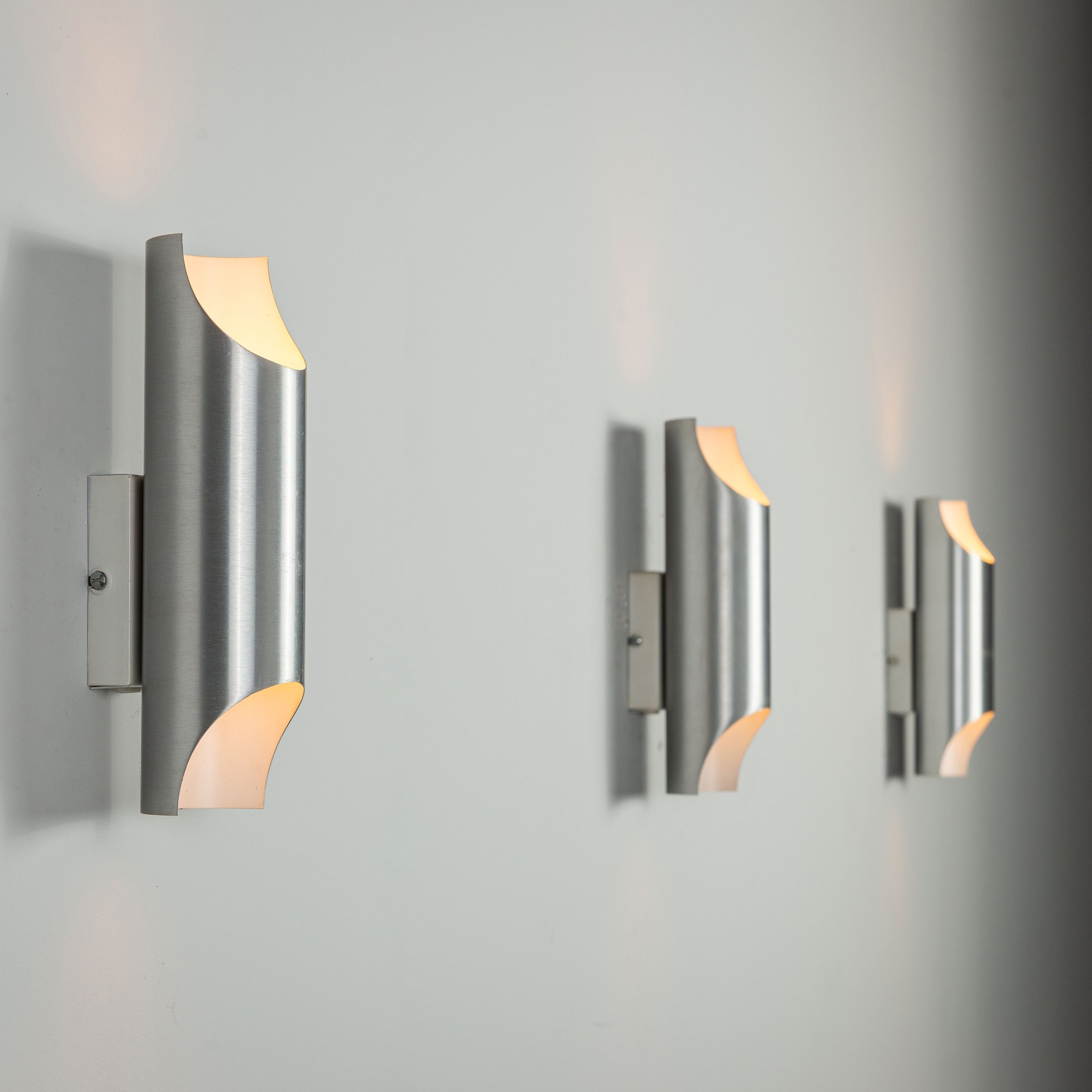 Set of three aluminium cylindrical wall lamps