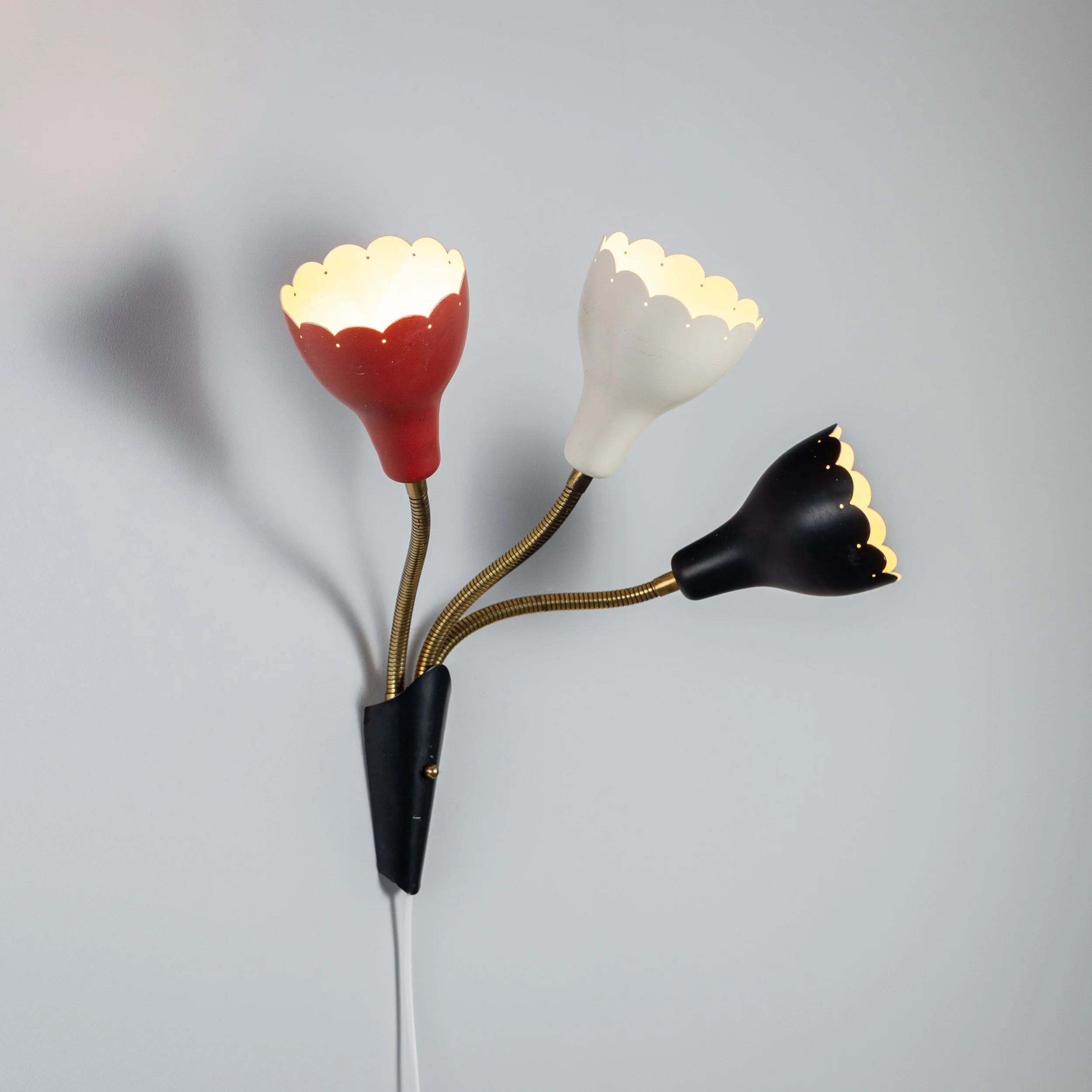 Adjustable wall lamp with three decorated shades