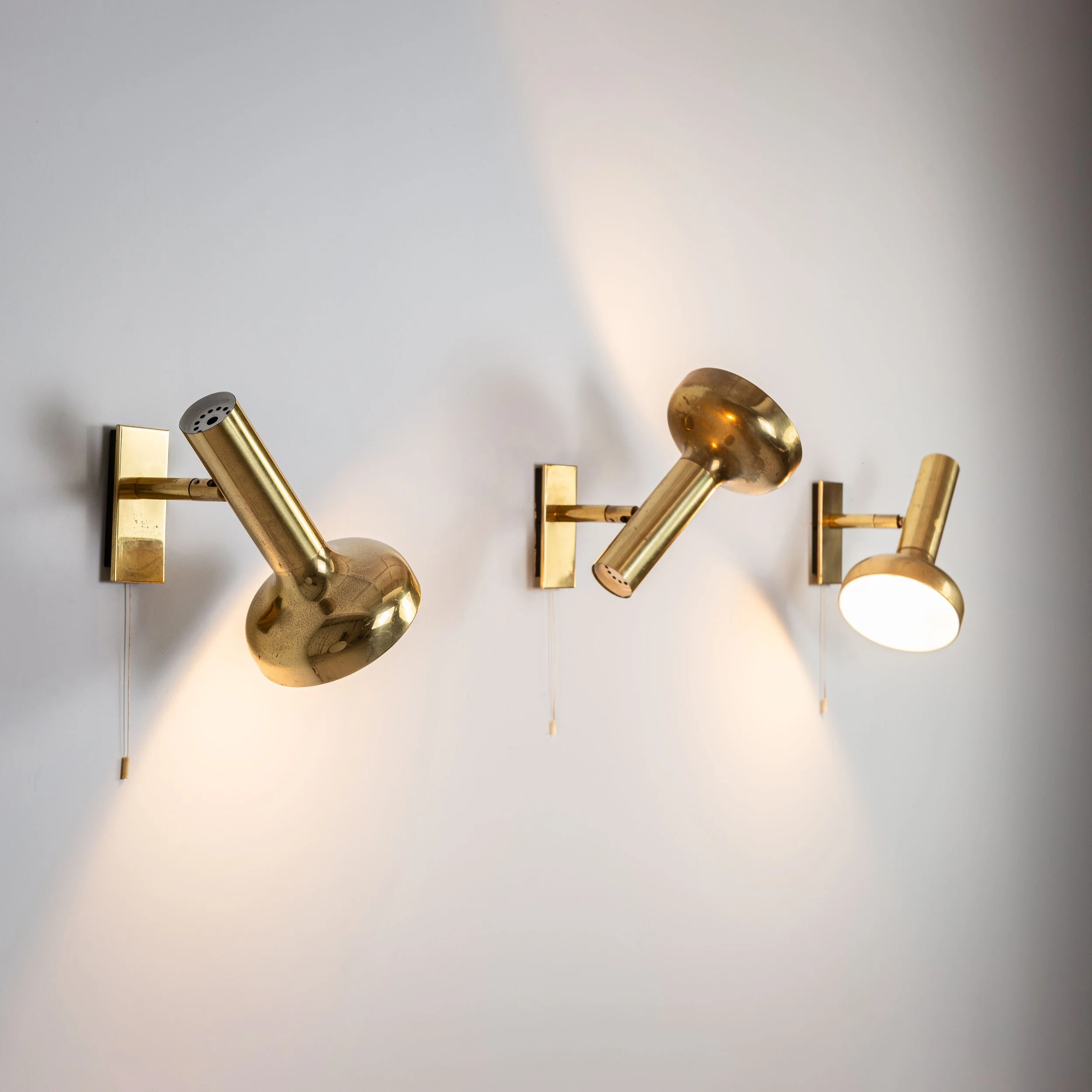 Set of three brass adjustable lamps