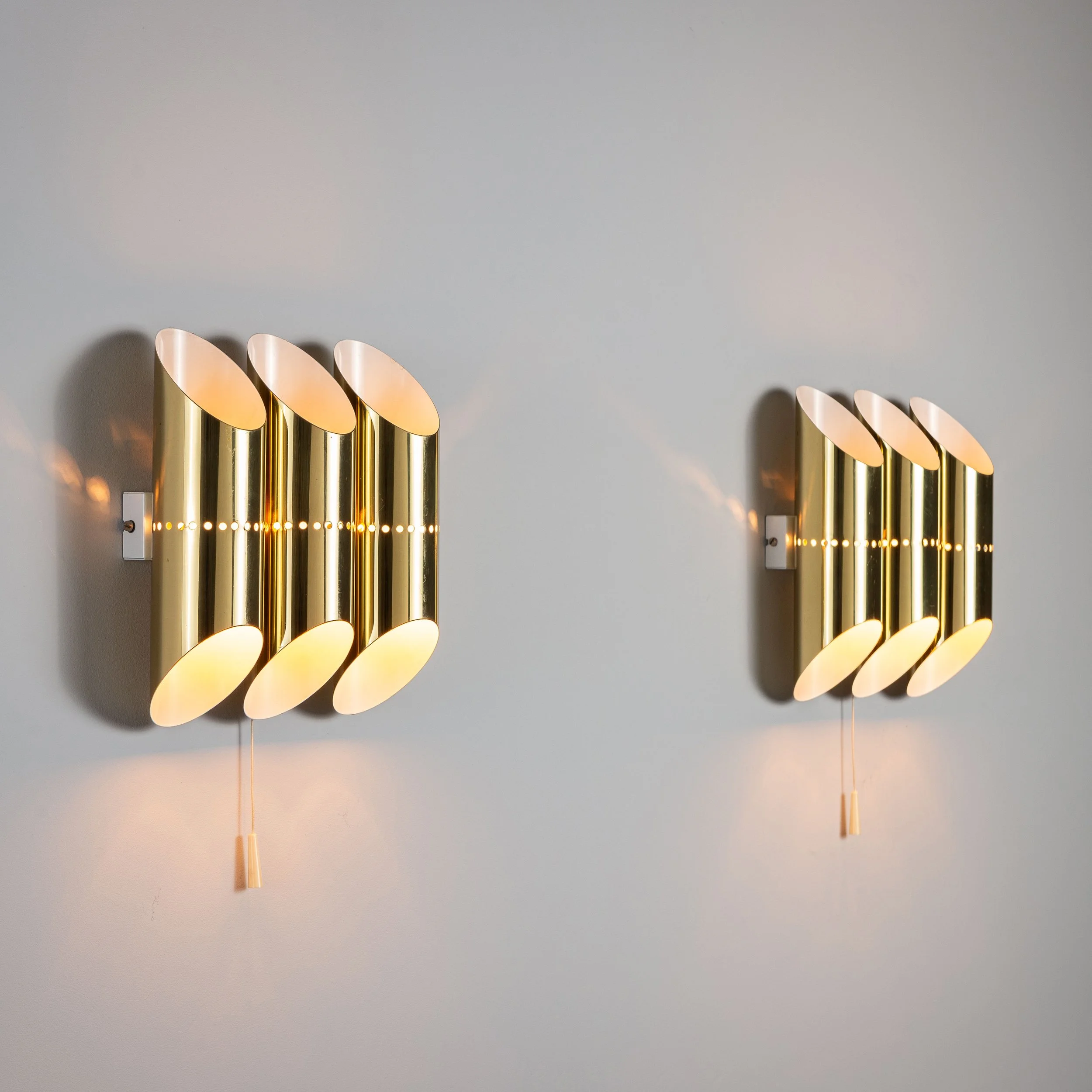 Pair of triple cylindrical wall lamps in brass with perforated shades