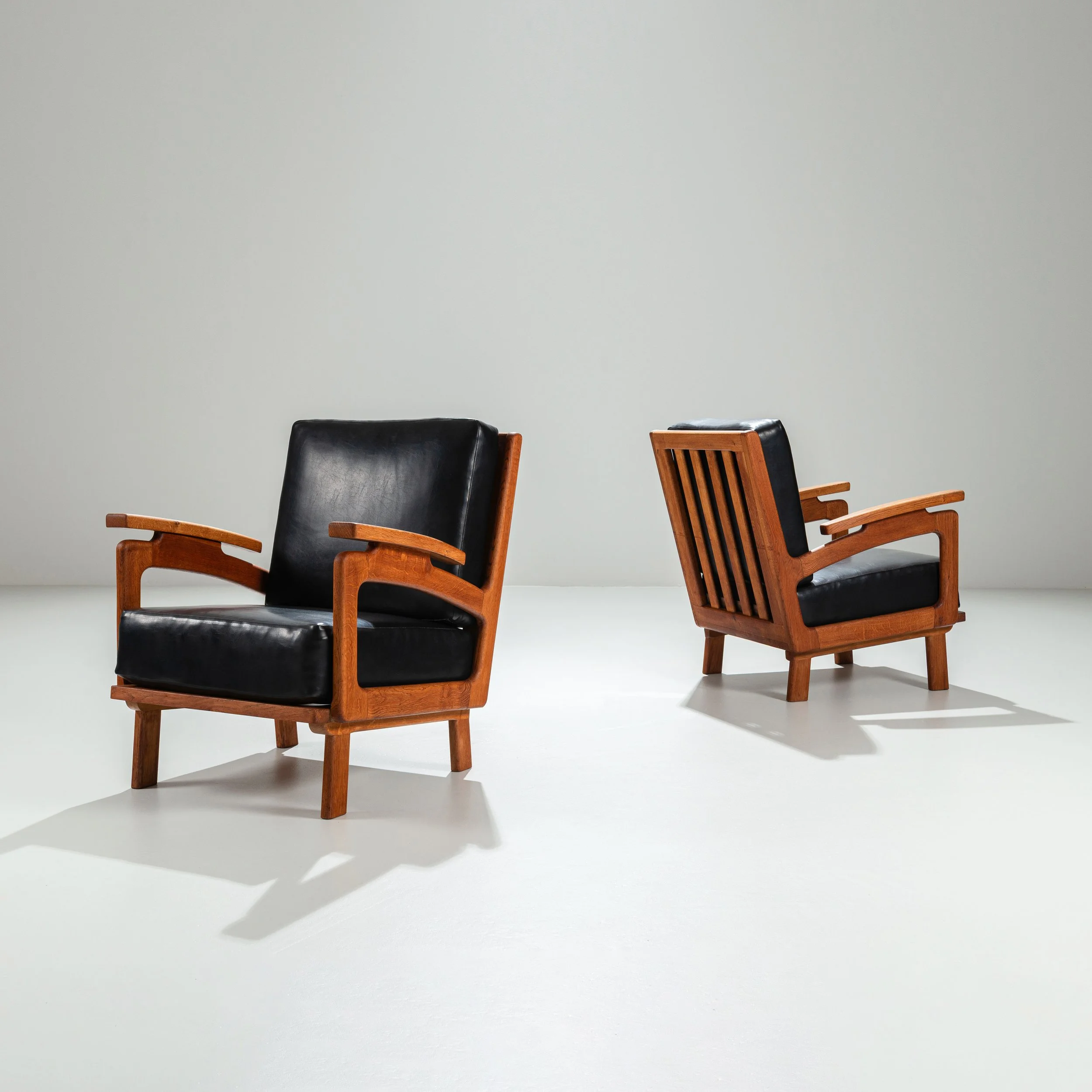 Pair of Belgian lounge chairs in solid oak with leather cushions