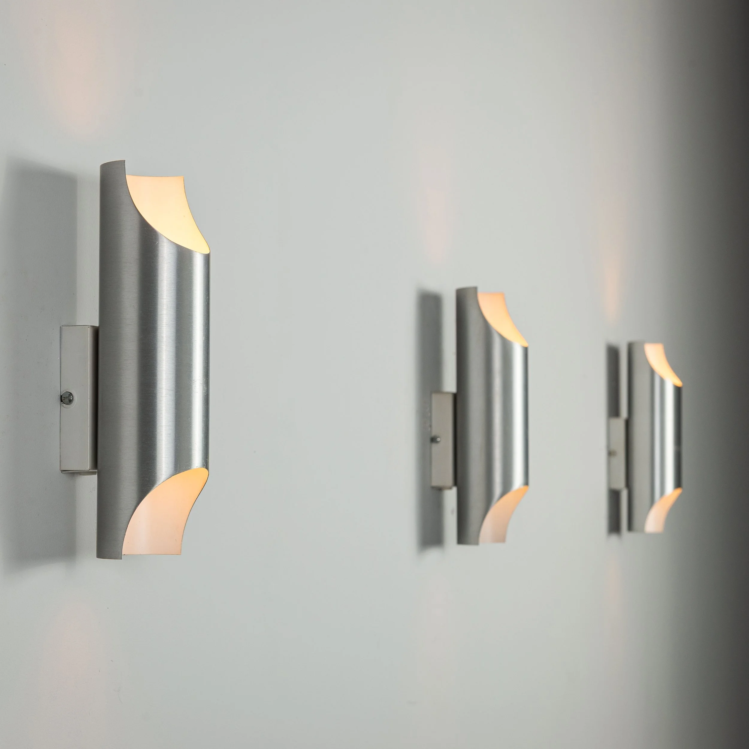 Set of three aluminium cylindrical wall lamps