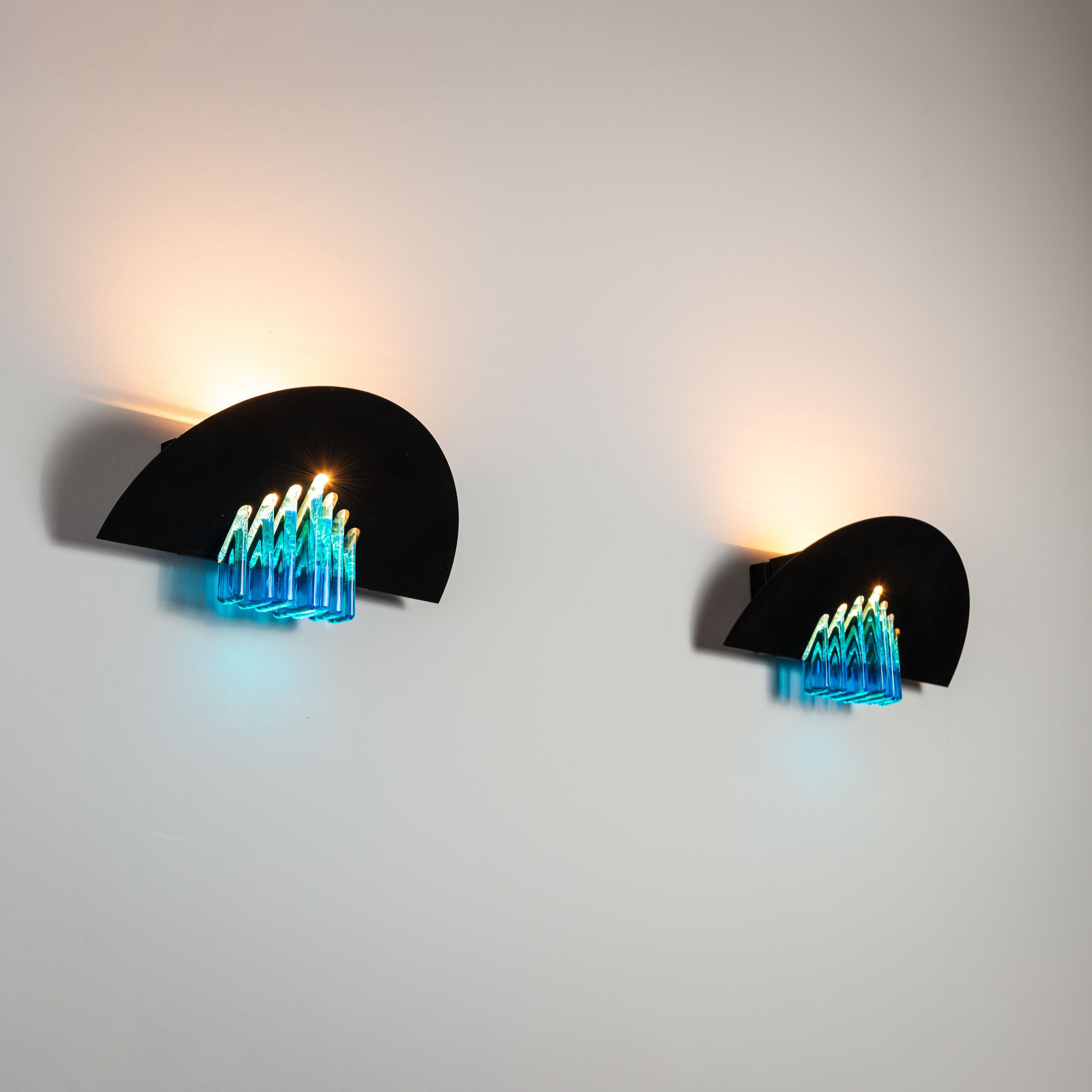 Pair of AV Mazzega wall lamps with black frames and blue glass decoration