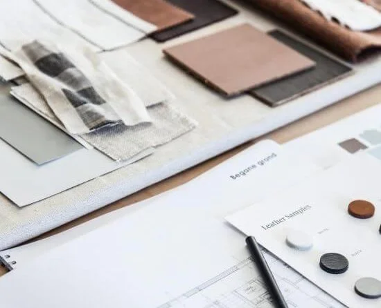 Design workspace with color swatches, fabric samples, and a color palette on a table